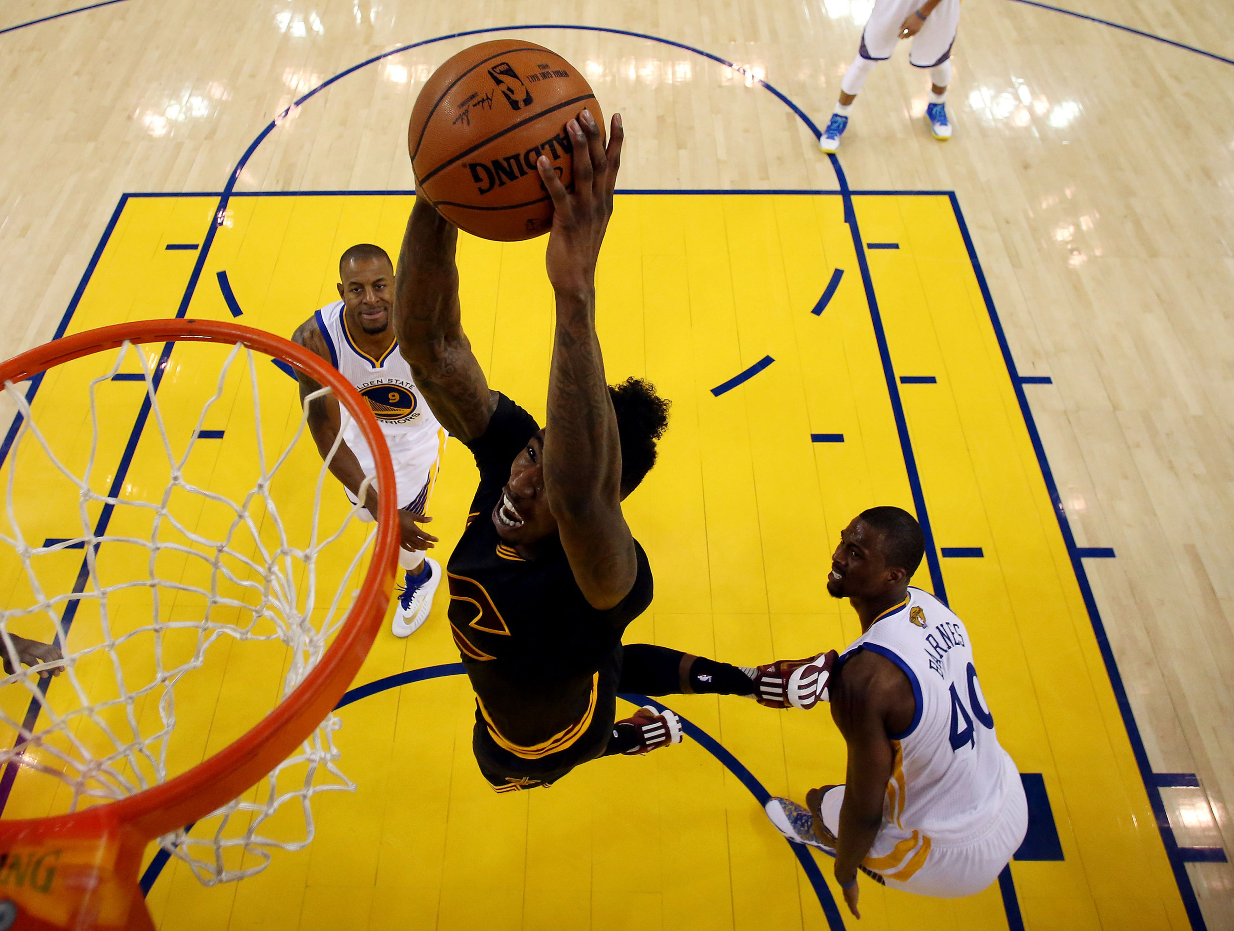 Jun 13, 2016; Oakland, CA, USA; Cleveland Cavaliers guard Iman Shumpert (4) dunks the ball against Golden State Warriors forward Harrison Barnes (40) in game five of the NBA Finals. Credit: Ezra Shaw-Pool Photo via USA TODAY Sports