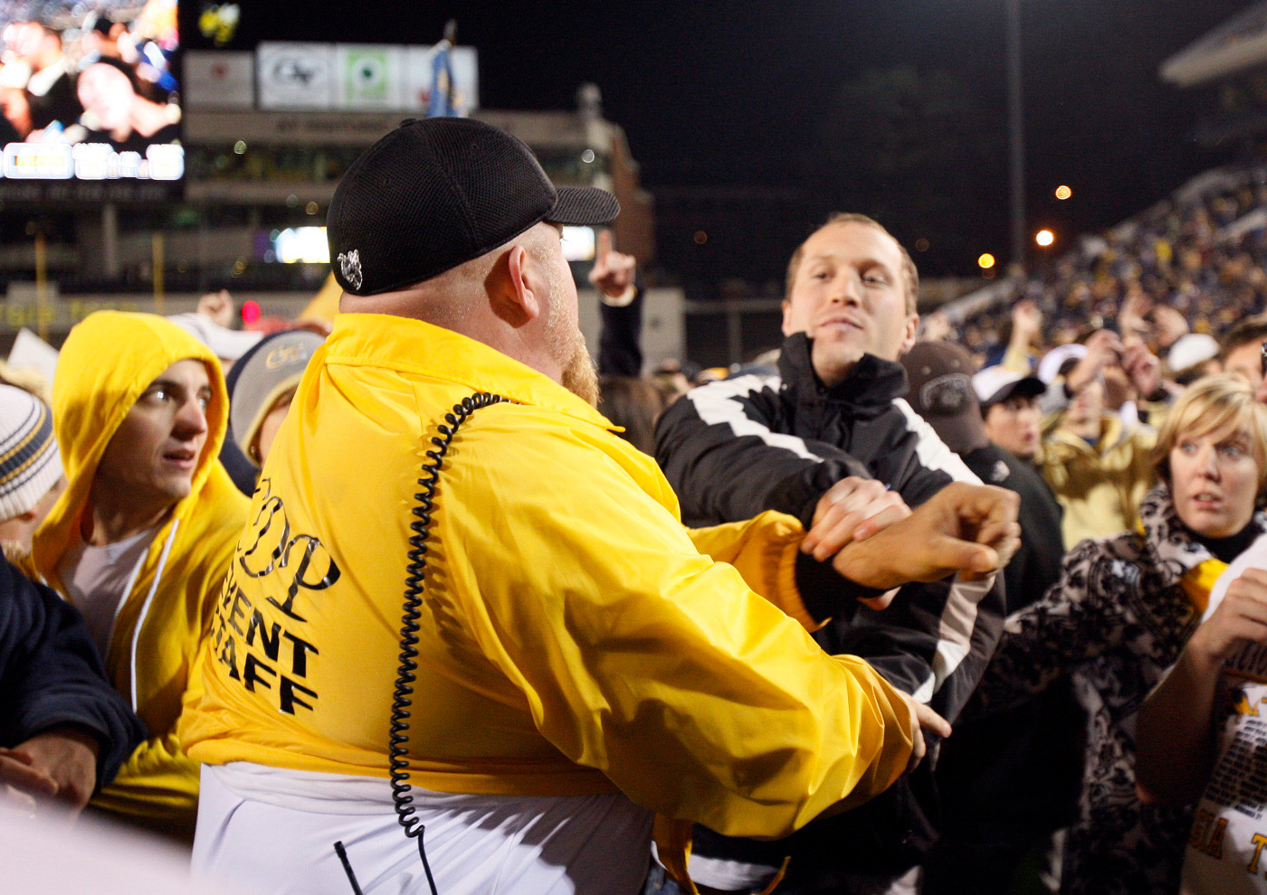 Security guards try to control a crowd after Georgia Tech defeated Virginia Tech 28-23 in an NCAA college football game in Atlanta, on Saturday, Oct. 17, 2009. (AP Photo/John Bazemore)
