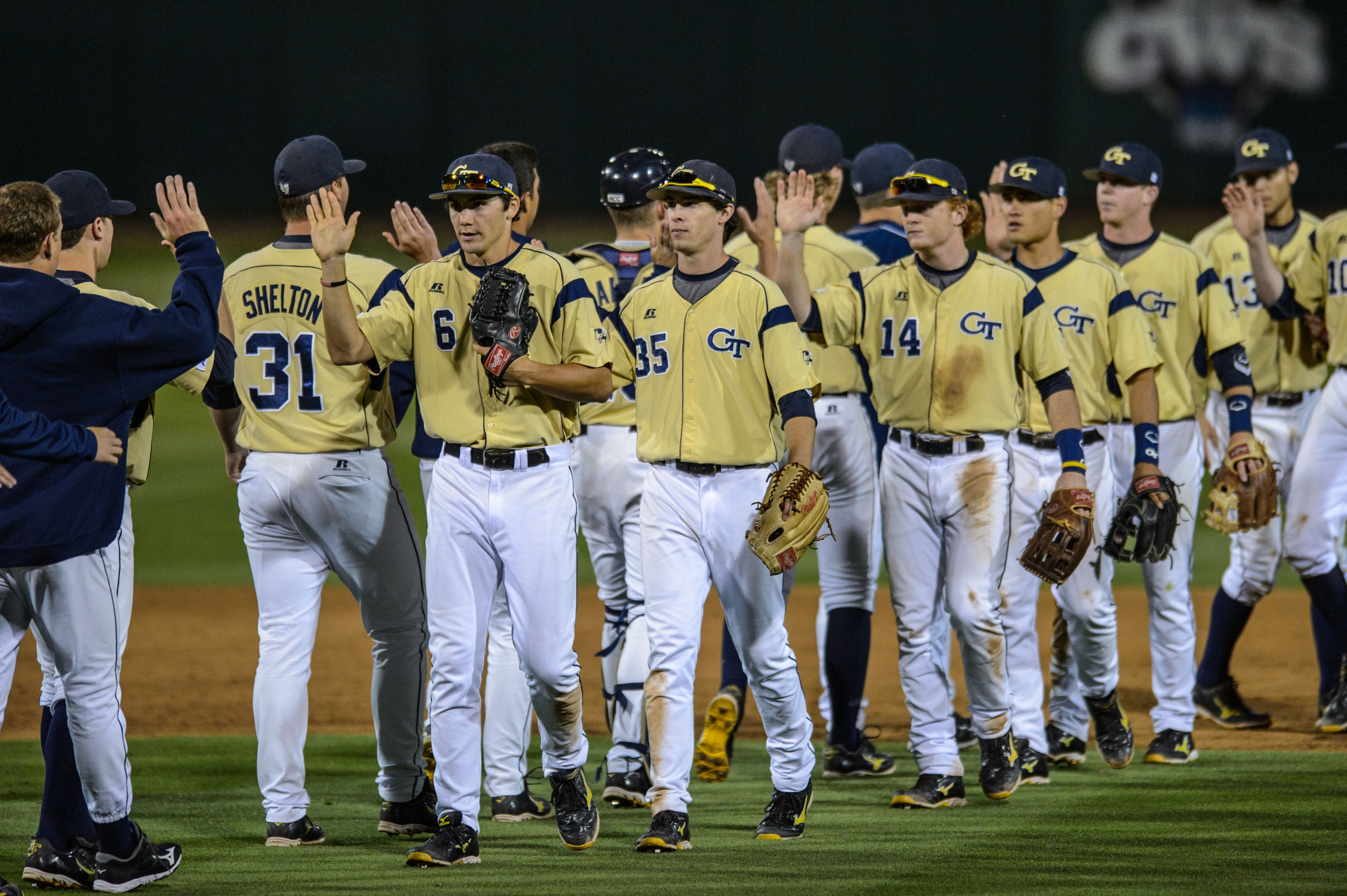 The team exchanges high fives after the win