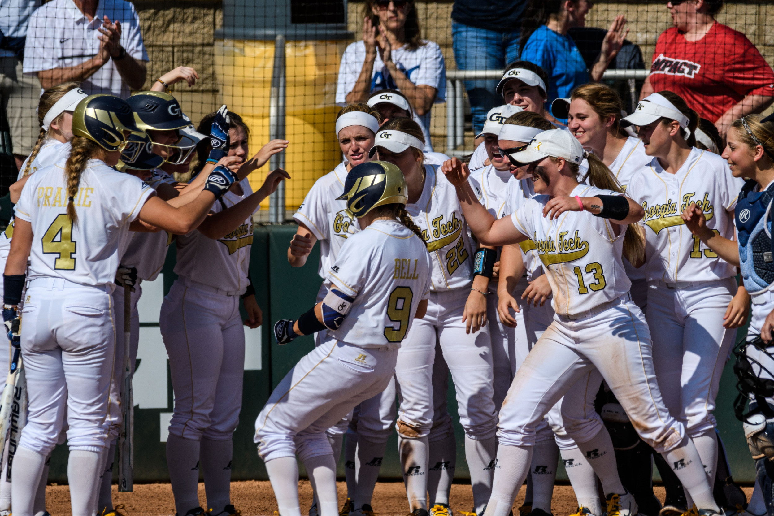 The team celebrates Malea Bell's home run