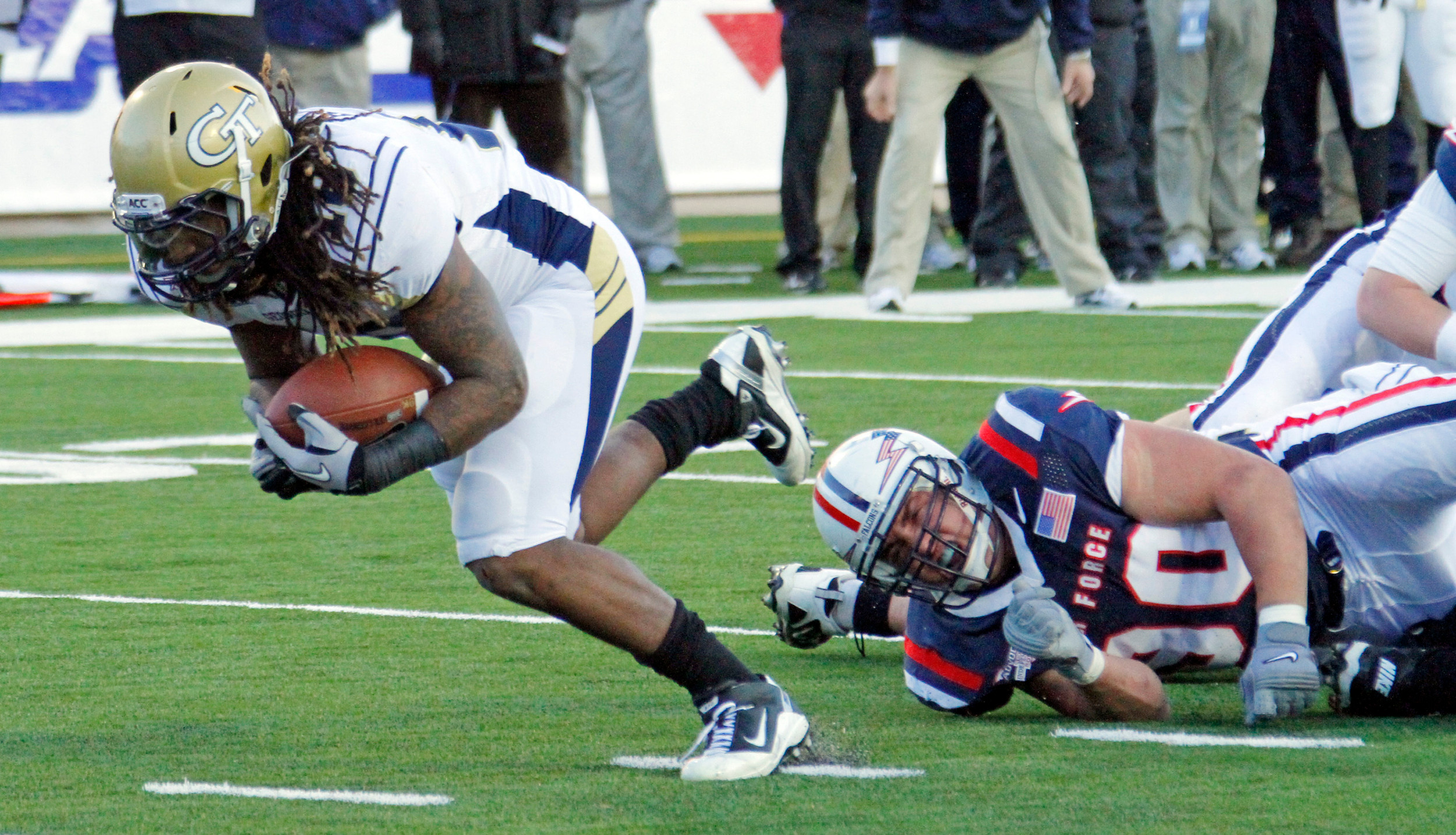 Georgia Tech running back Anthony Allen (18) dives past Air Force defensive lineman Rick Ricketts (90) for a late first quarter touchdown during their NCAA college footbal game at the Independence Bowl in Shreveport, La., Monday, Dec. 27, 2010. (AP Photo/Rogelio V. Solis)