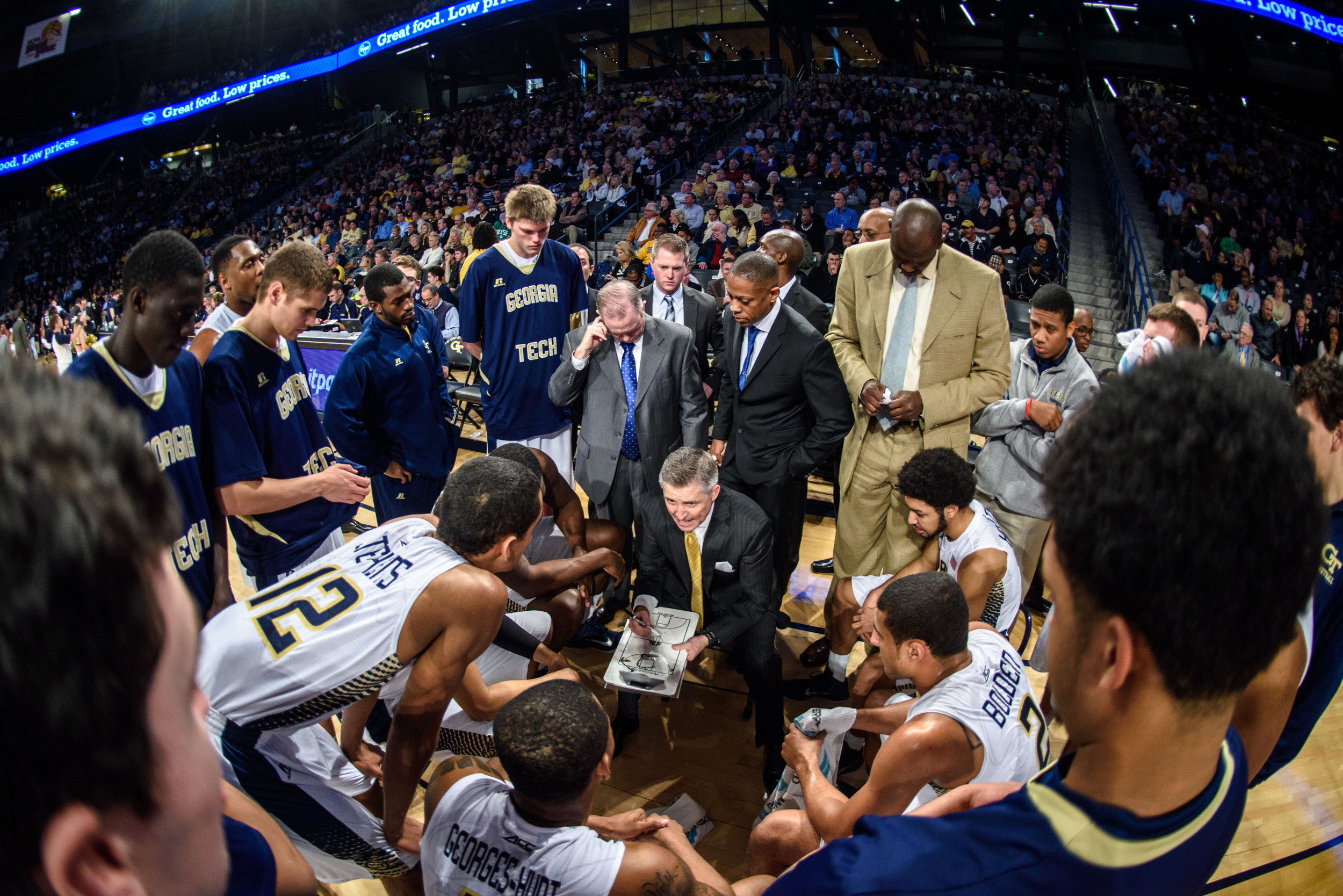 Coach Brian Gregory speaks to the team during a timeout