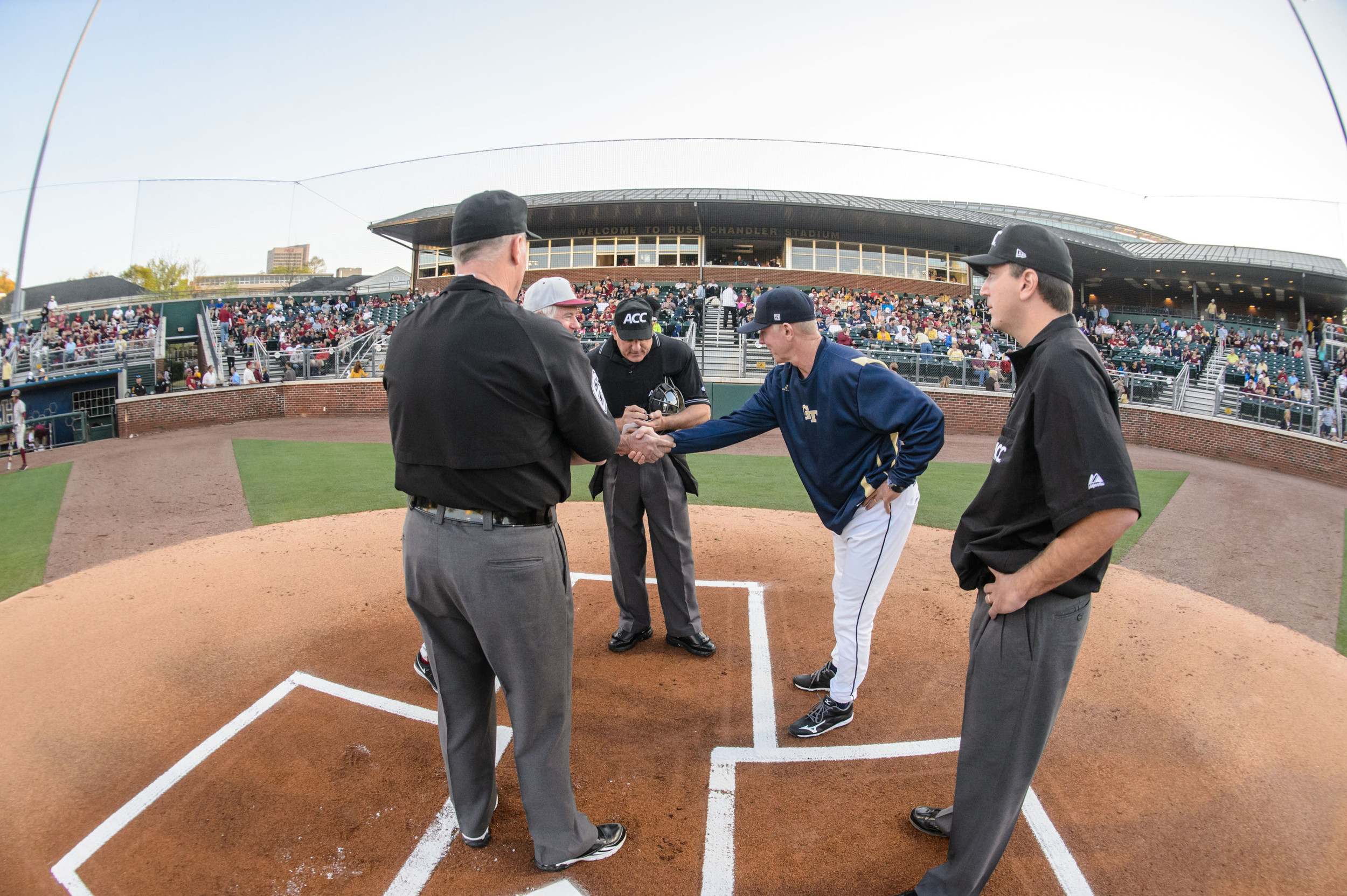 Coach Danny Hall (17) of Georgia Tech and Coach Mike Martin of Florida State meet with the umpires
