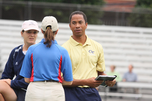 Head Coach Bryan Shelton and assistant coach Anca Dumitrescu speak with an official