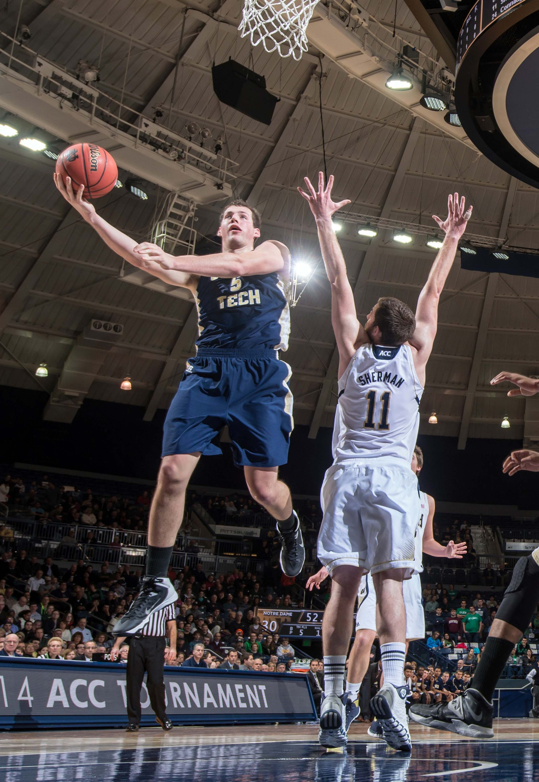 Feb 26, 2014; South Bend, IN, USA; Georgia Tech Yellow Jackets center Daniel Miller (5) goes up for a shot as Notre Dame Fighting Irish center Garrick Sherman (11) defends in the first half at the Purcell Pavilion. Mandatory Credit: Matt Cashore-USA TODAY Sports