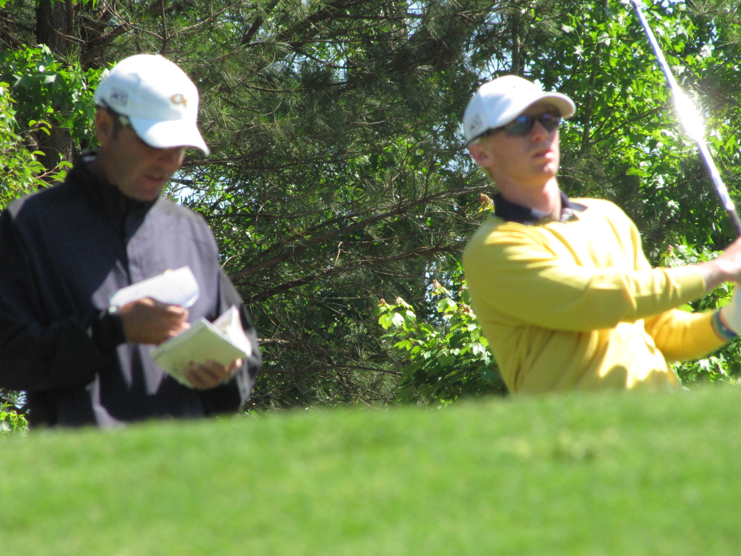 Assistant coach Brennan Webb and Anders Albertson wait to his on the 6th tee during the final round of the NCAA Raleigh Regional.