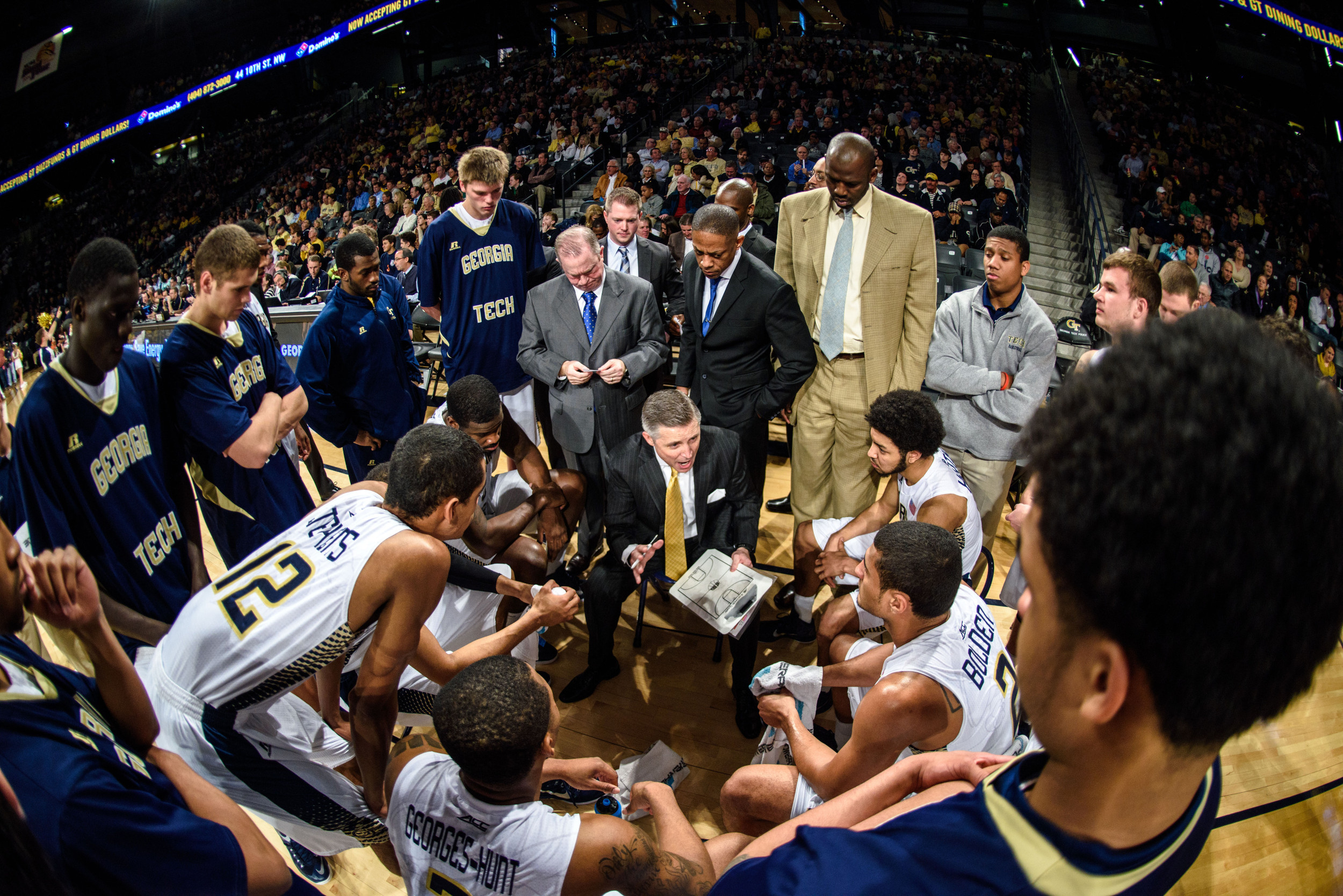 Coach Brian Gregory speaks to the team during a timeout