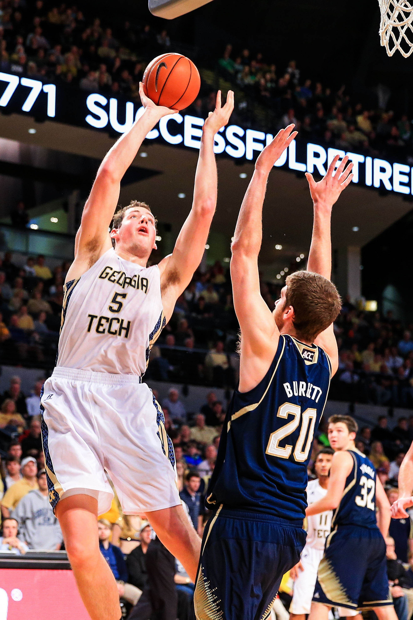 Jan 11, 2014; Atlanta, GA, USA; Georgia Tech Yellow Jackets center Daniel Miller (5) shoots a basket over Notre Dame Fighting Irish forward Austin Burgett (20) in the second half at Hank McCamish Pavilion. Georgia Tech won 74-69. Mandatory Credit: Daniel Shirey-USA TODAY Sports