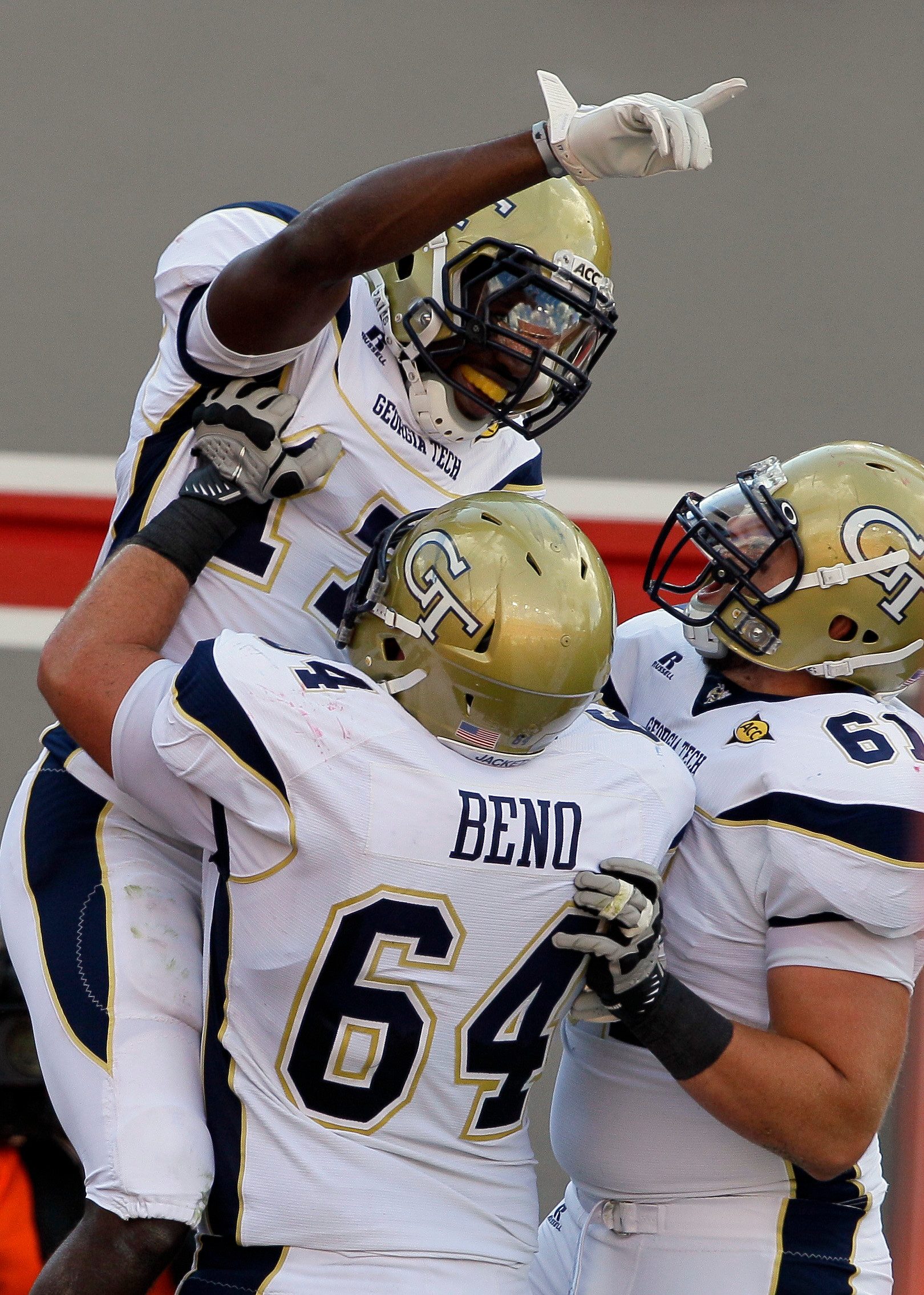 Georgia Tech's Orwin Smith, top, celebrates his touchdown against North Carolina State with Ray Beno (64) and Phil Smith (61). (AP Photo/Gerry Broome)