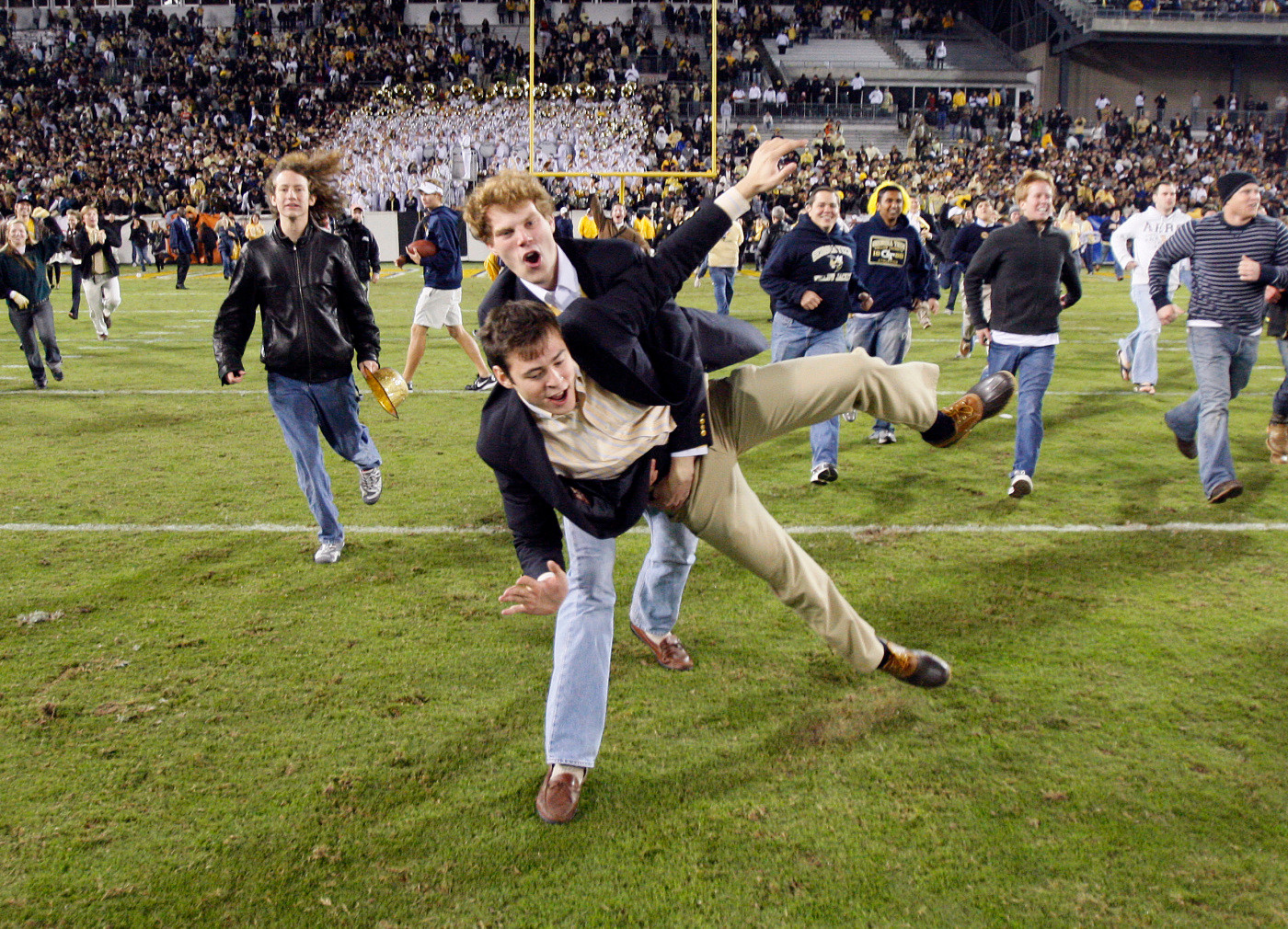 Georgia Tech fans rush the field after Georgia Tech defeated Virginia Tech 28-23 in an NCAA college football game in Atlanta, Saturday, Oct. 17, 2009. (AP Photo/John Bazemore)