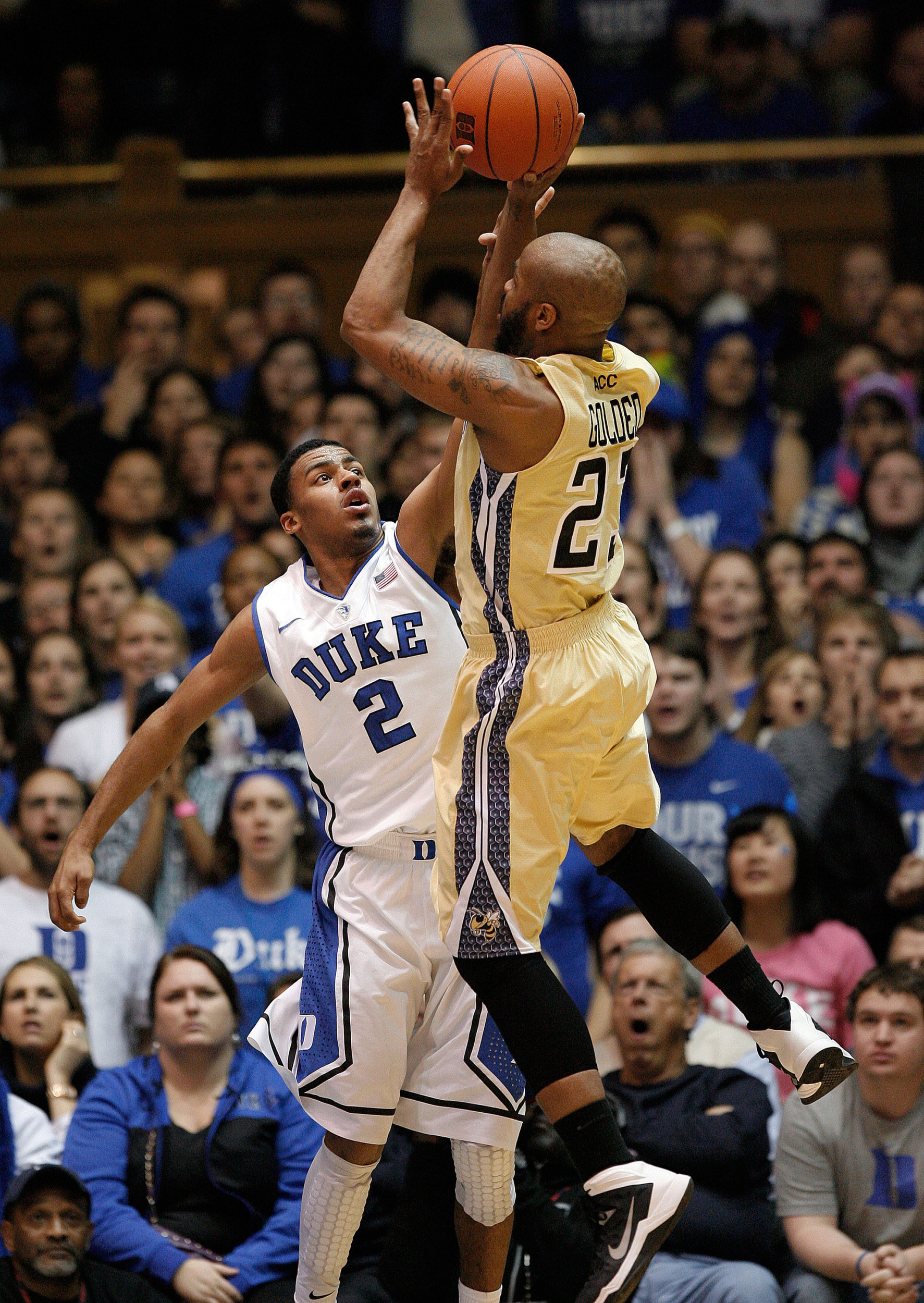Jan 7, 2014; Durham, NC, USA; Georgia Tech Yellow Jackets guard Trae Golden (23) shoots over Duke Blue Devils guard Quinn Cook (2) at Cameron Indoor Stadium. Mandatory Credit: Mark Dolejs-USA TODAY Sports