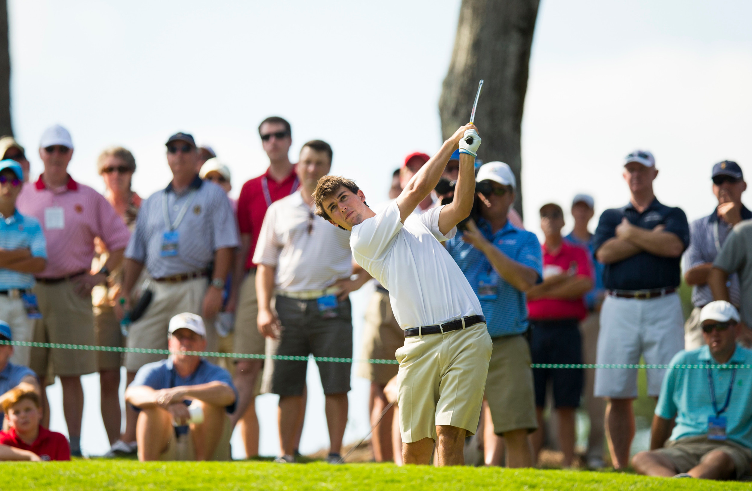 Ollie Schniederjans plays his tee shot on the 15th hole during the third round of match play at the 2014 U.S. Amateur at Atlanta Athletic Club in Johns Creek, Ga. on Thursday, Aug. 14, 2014. (Copyright USGA/John Mummert)