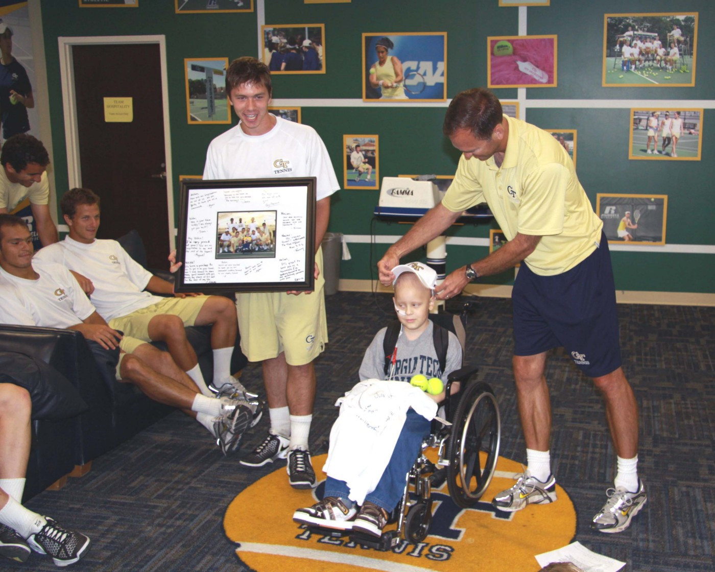Eliot Potvin presents Nolan with a signed team picture.