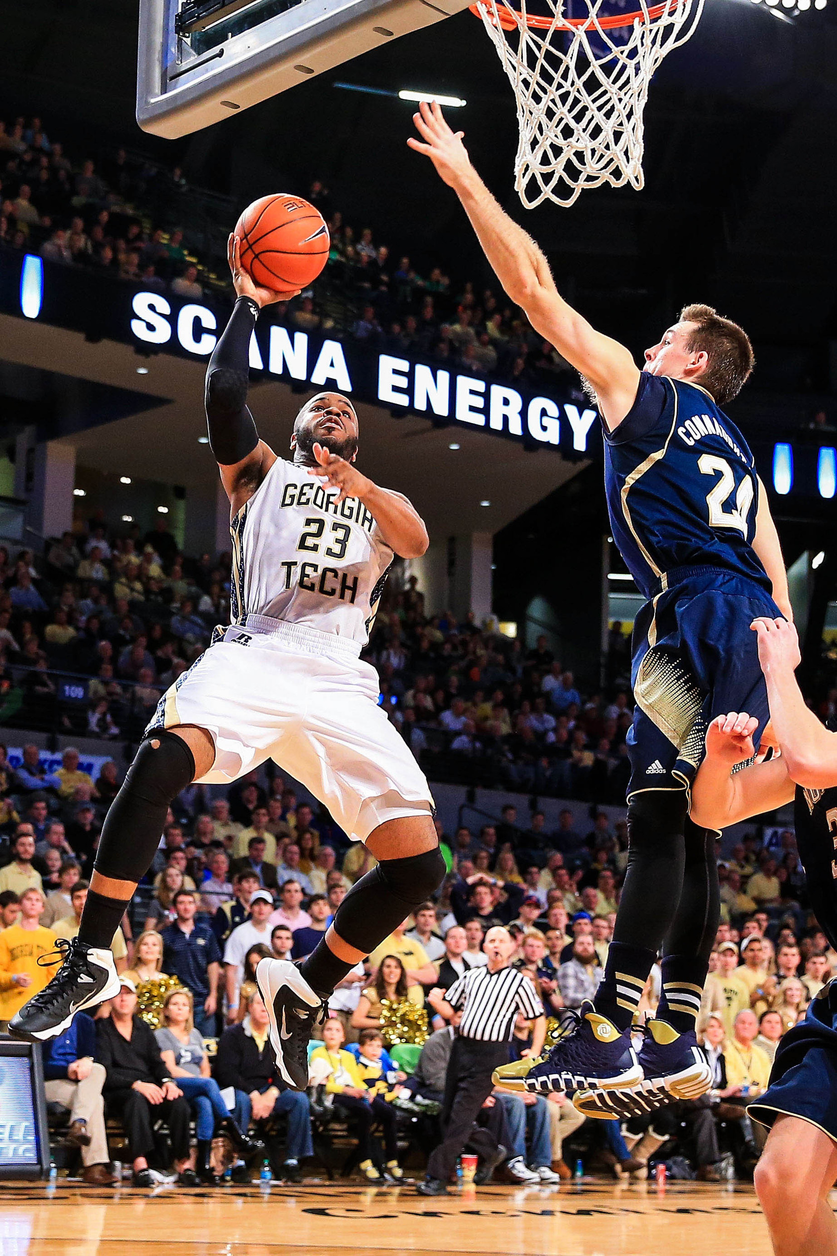 Jan 11, 2014; Atlanta, GA, USA; Georgia Tech Yellow Jackets guard Trae Golden (23) shoots a basket past Notre Dame Fighting Irish guard/forward Pat Connaughton (24) in the second half at Hank McCamish Pavilion. Georgia Tech won 74-69. Mandatory Credit: Daniel Shirey-USA TODAY Sports