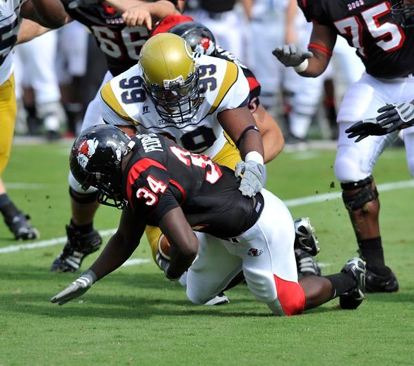 Vance Walker (99) brings down the Gardner-Webb running back. (Photo by LensEffects)