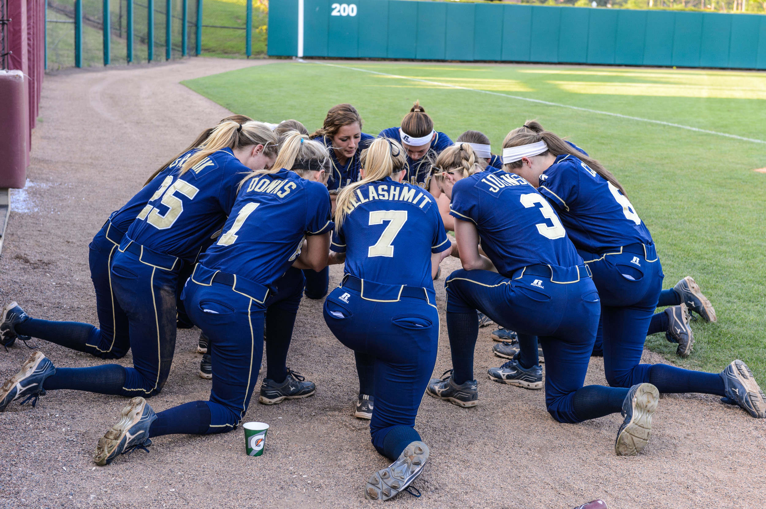 The team says a prayer before the start of the game.