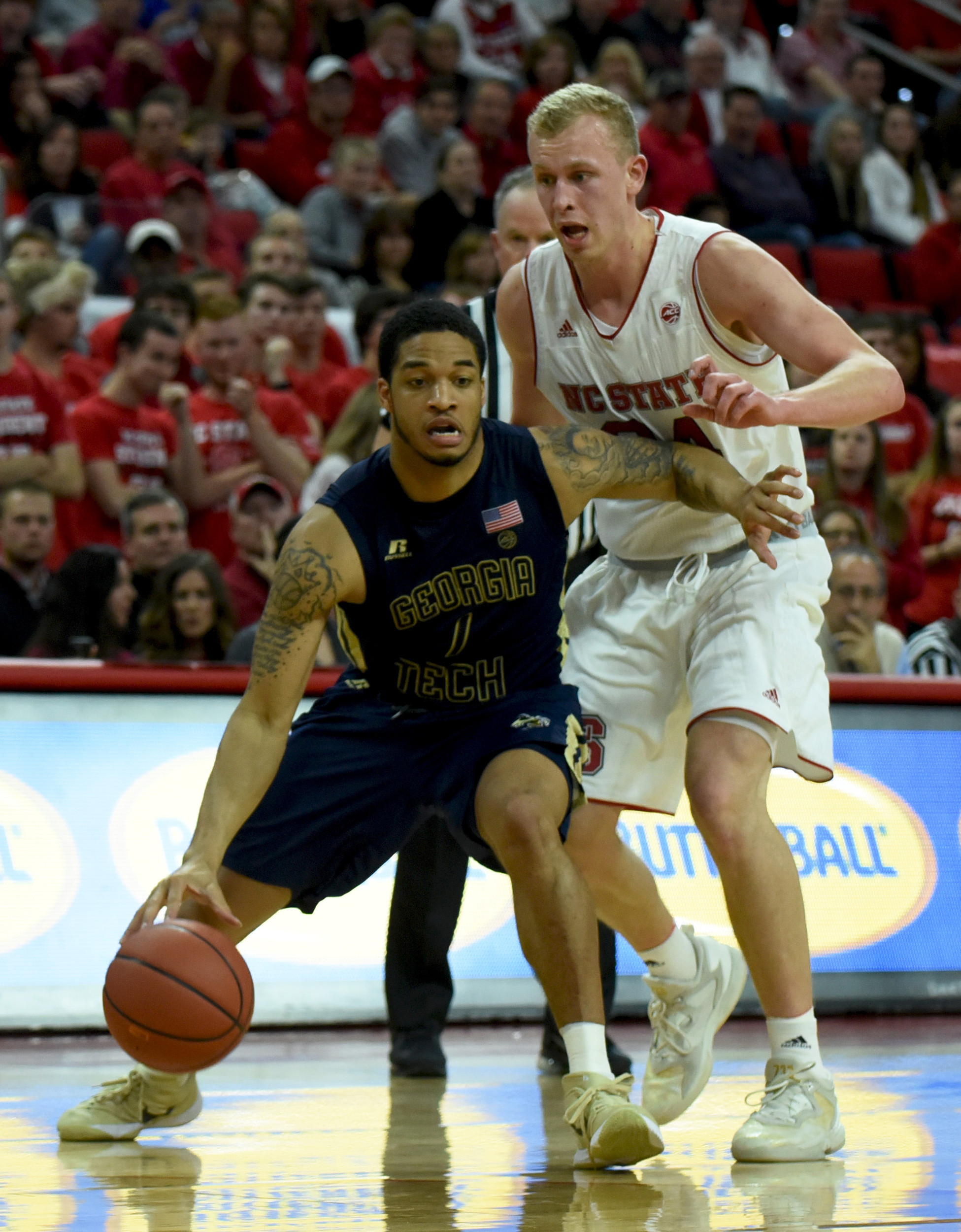 Guard Justin Moore drives to the basket as North Carolina State Wolfpack guard Maverick Rowan defends during the second half. The Yellow Jackets won 86-76. Credit: Rob Kinnan-USA TODAY Sports