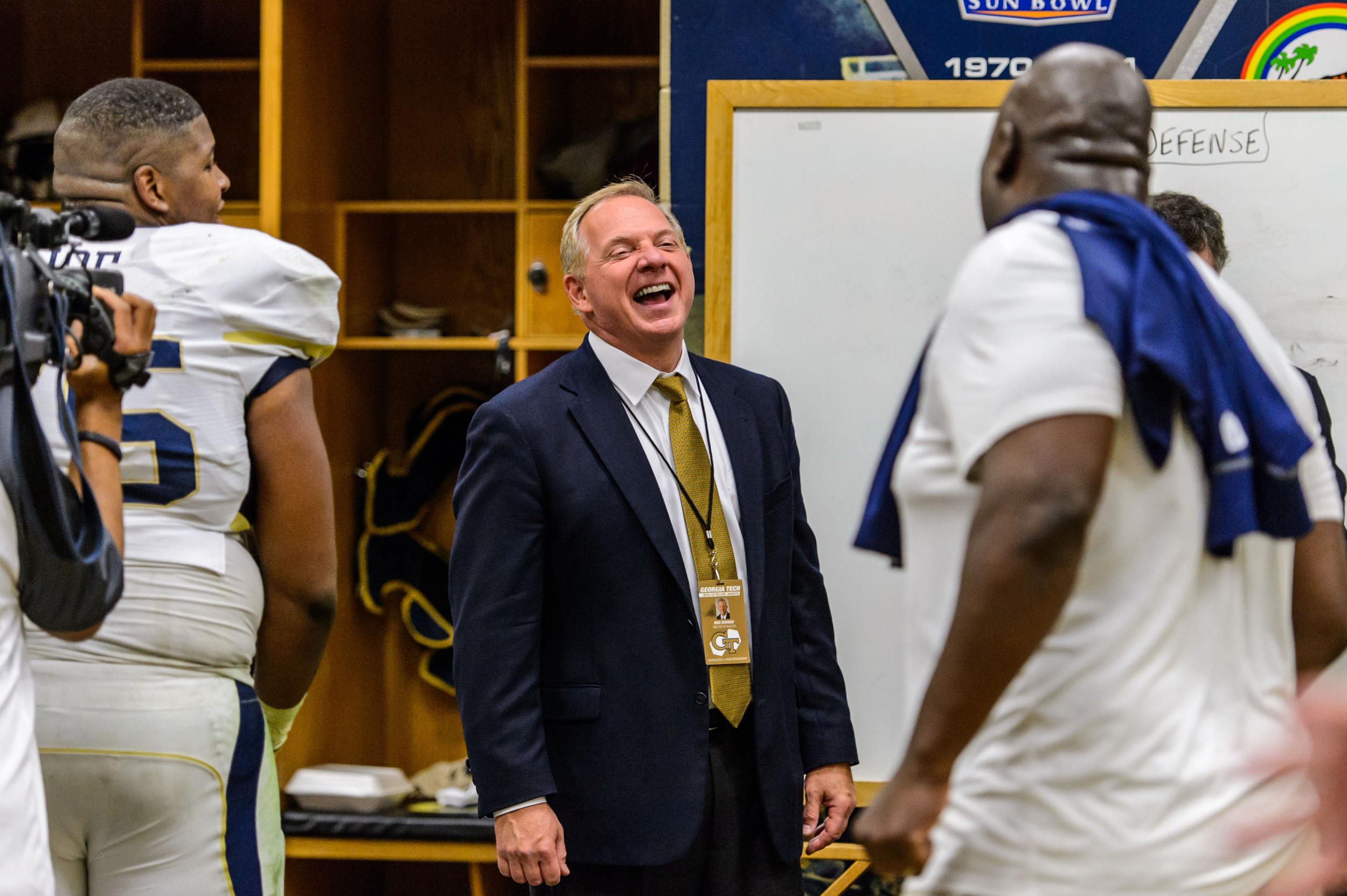 Director of Athletics Mike Bobinski enjoys a moment in the locker room after the upset victory