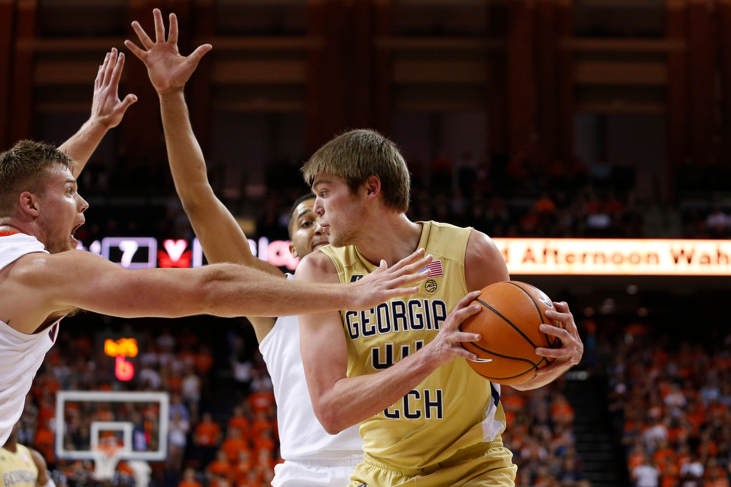 Feb 21, 2018; Charlottesville, VA, USA; Georgia Tech Yellow Jackets center Ben Lammers (44) controls the ball between Virginia Cavaliers center Jack Salt (33) and Cavaliers forward Isaiah Wilkins (21) during the first half at John Paul Jones Arena. Mandatory Credit: Amber Searls-USA TODAY Sports