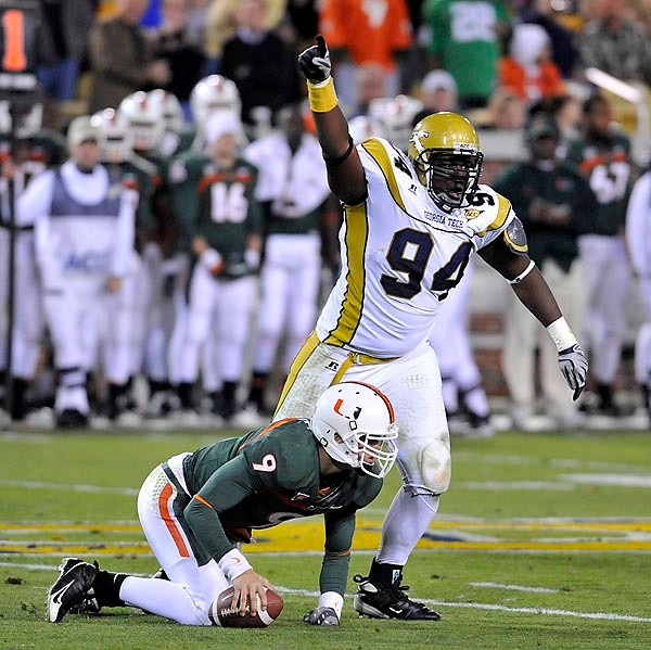 Elris Anyaibe (94) celebrates a sack of Miami QB Robert Marve. (Photo by LensEffects)