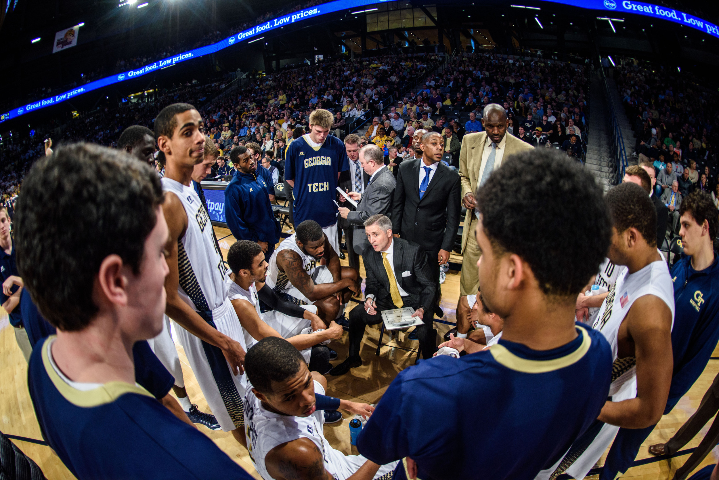 Coach Brian Gregory speaks to the team during a timeout