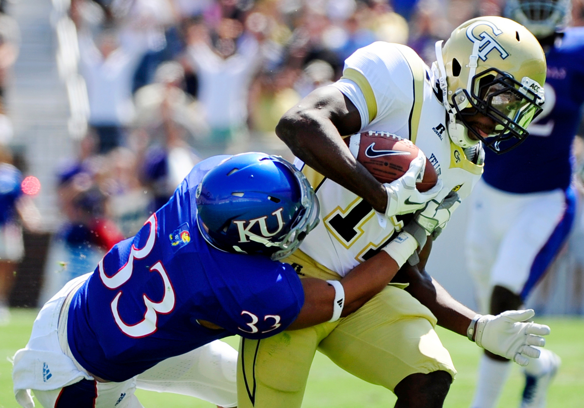 Georgia Tech running back Orwin Smith, right, catches the 41-yard pass in front of Kansas cornerback Tyler Patmon (33) during the first half of their NCAA college football game at Bobby Dodd Stadium in Atlanta on Saturday, Sept. 17, 2011. (AP Photo/David Tulis)