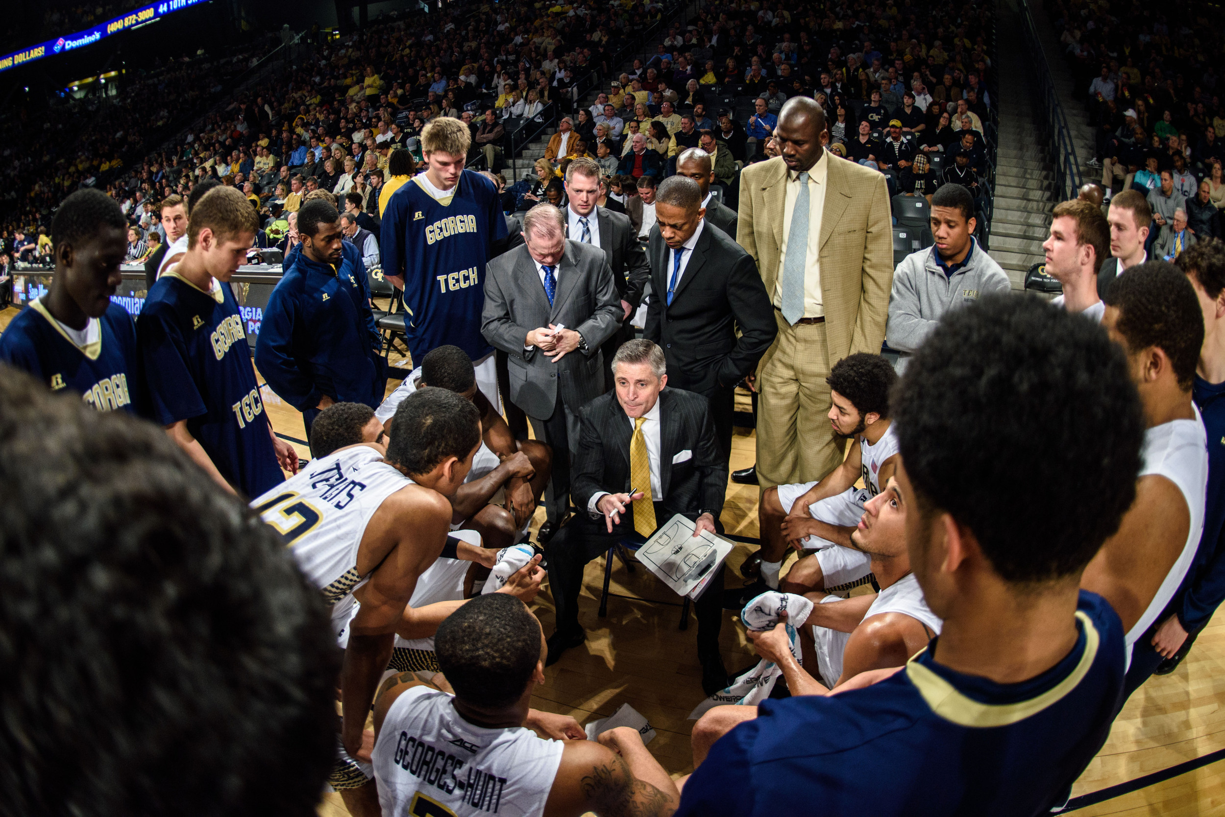 Coach Brian Gregory speaks to the team during a timeout