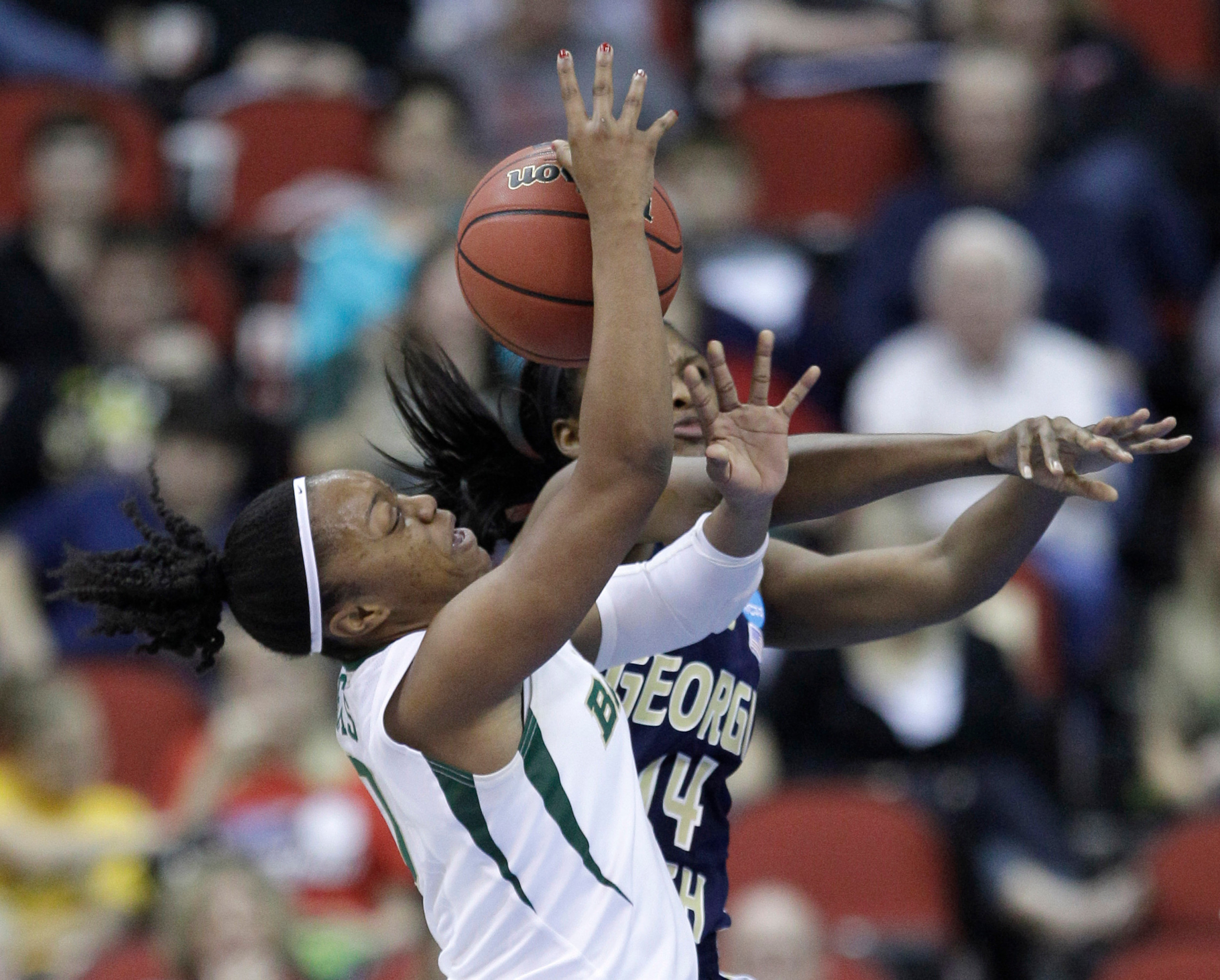 Baylor guard Odyssey Sims is fouled by Georgia Tech center LaQuananisha Adams, rear, while driving to the basket during the first half. (AP Photo/Charlie Neibergall)