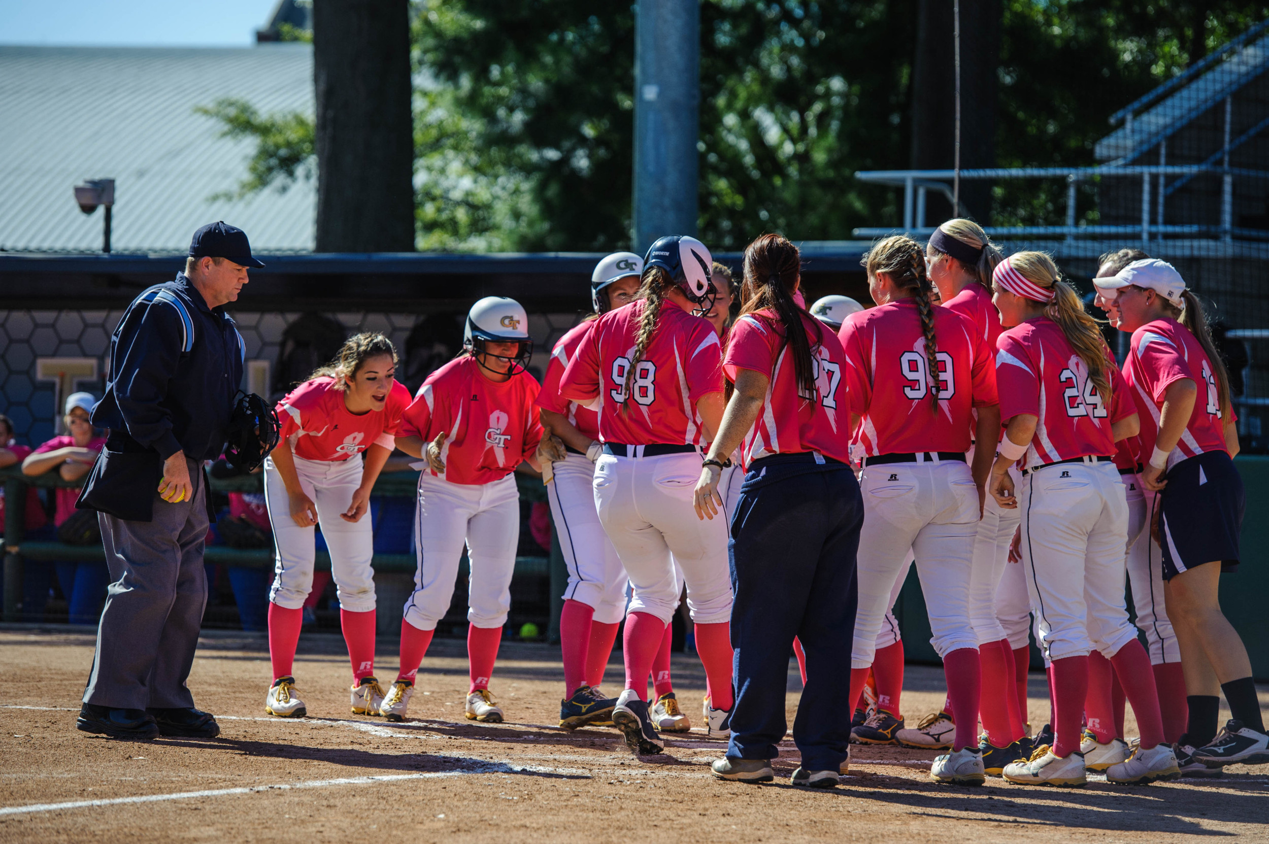 The team celebrates a home run by Jenna Goodrich (98)
