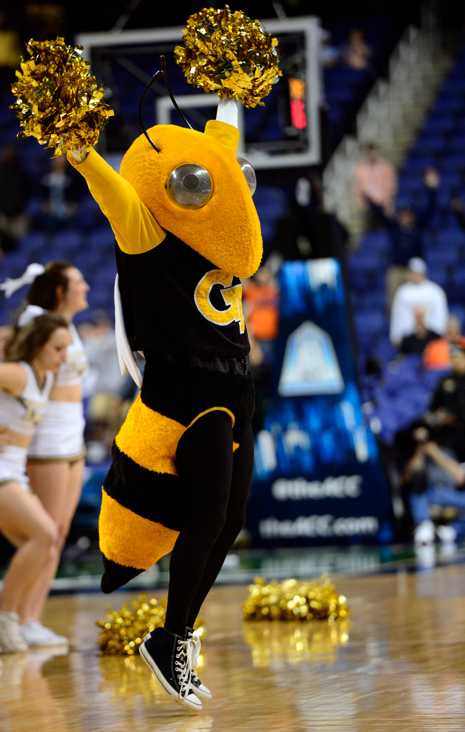 Mar 12, 2014; Greensboro, NC, USA; Georgia Tech Yellow Jackets mascot cheers during a timeout against the Boston College Eagles in the second half during the first round of the ACC Tournament at Greensboro Coliseum. Georgia Tech defeated Boston College 73-70 in overtime. Mandatory Credit: John David Mercer-USA TODAY Sports