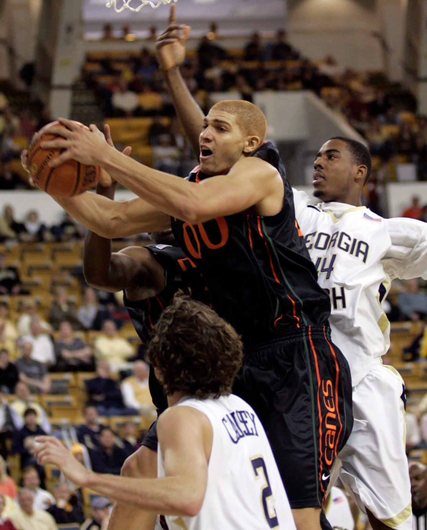 Miami forward Jimmy Graham (00) goes to the basket against Georgia Techs' Alade Aminu, right, and guard Matt Causey (2) during the first half of a college basketball game Sunday, Feb. 17, 2008, in Atlanta. (AP Photo/John Amis)