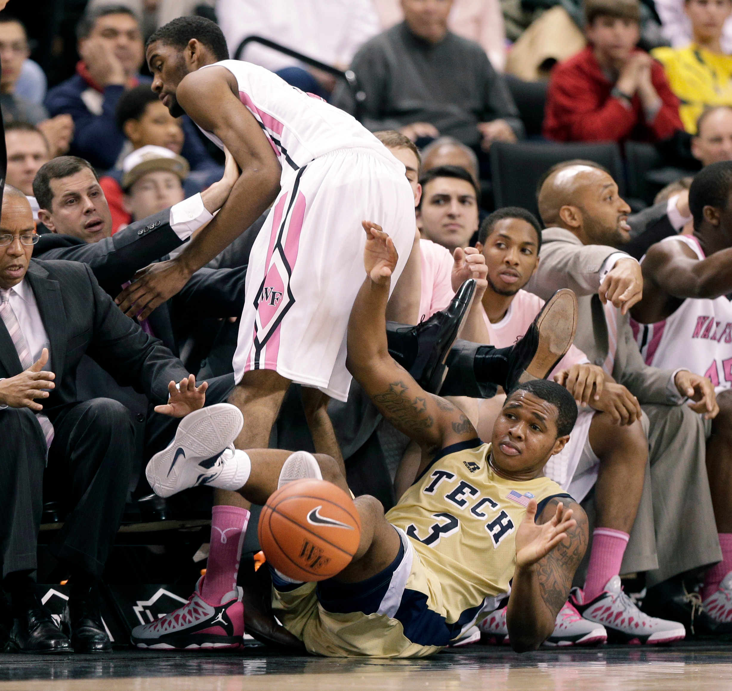 Georgia Tech's Marcus Georges-Hunt (3) and Wake Forest's Aaron Rountree III (33) fall out of bounds as they chase a loose ball during the second half. (AP Photo/Chuck Burton)