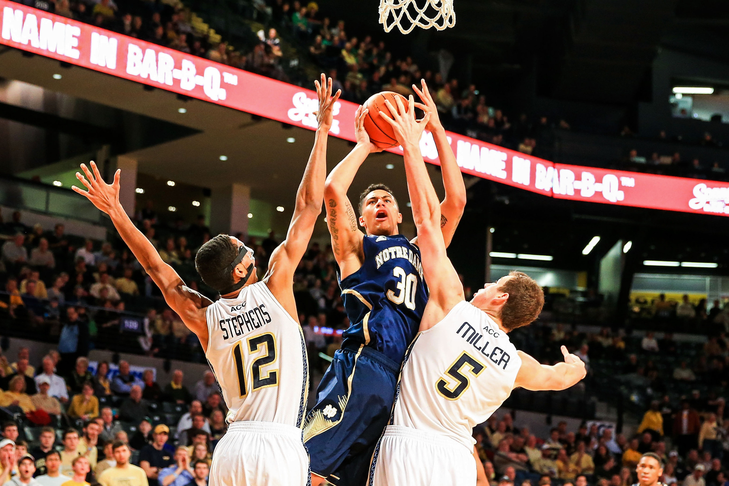 Jan 11, 2014; Atlanta, GA, USA; Notre Dame Fighting Irish forward Zach Auguste (30) shoots a basket between Georgia Tech Yellow Jackets forward Quinton Stephens (12) and center Daniel Miller (5) in the first half at Hank McCamish Pavilion. Mandatory Credit: Daniel Shirey-USA TODAY Sports