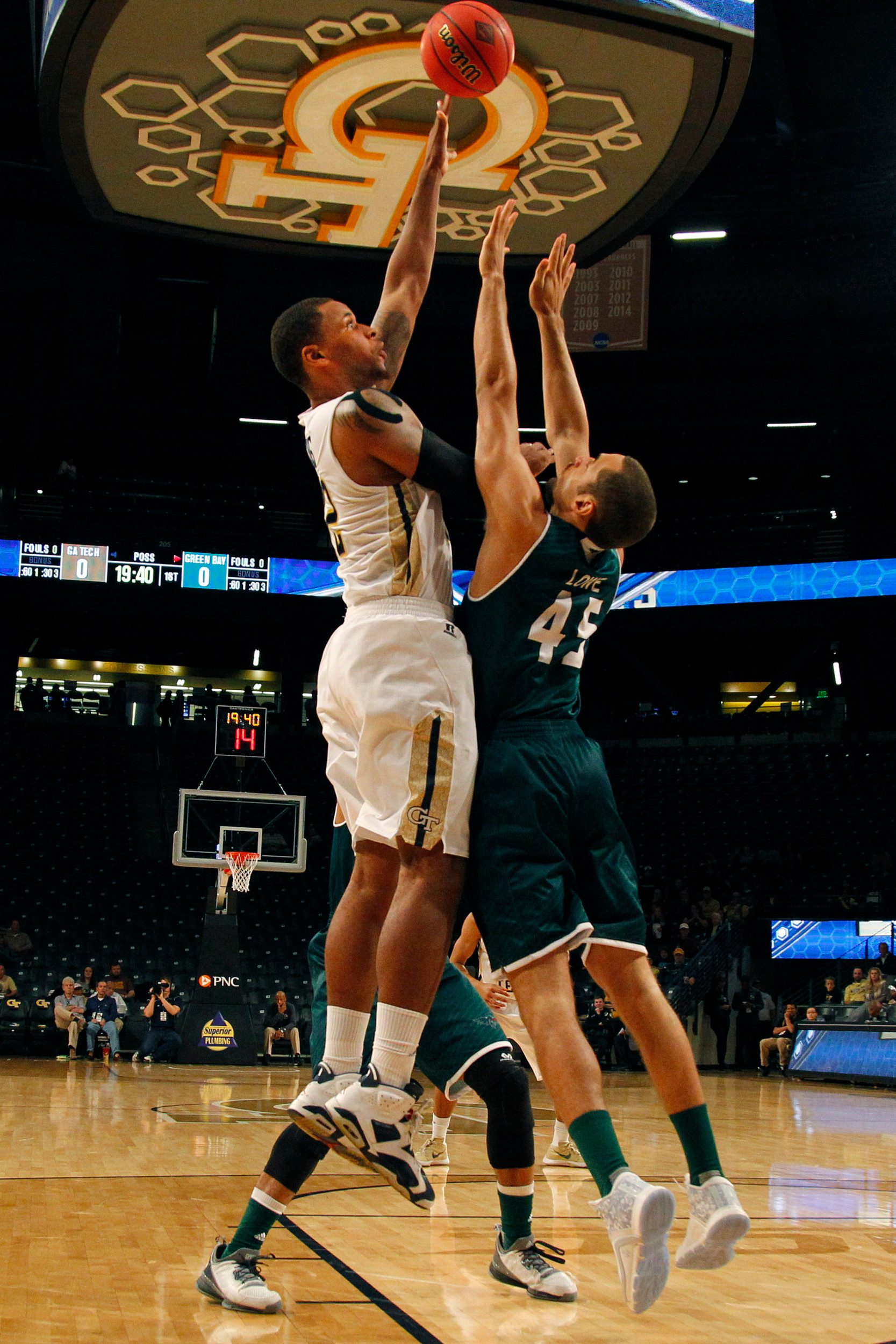 Yellow Jackets forward Nick Jacobs shoots the ball over Green Bay Phoenix forward Kenneth Lowe in the first half at McCamish Pavilion. Credit: Brett Davis-USA TODAY Sports