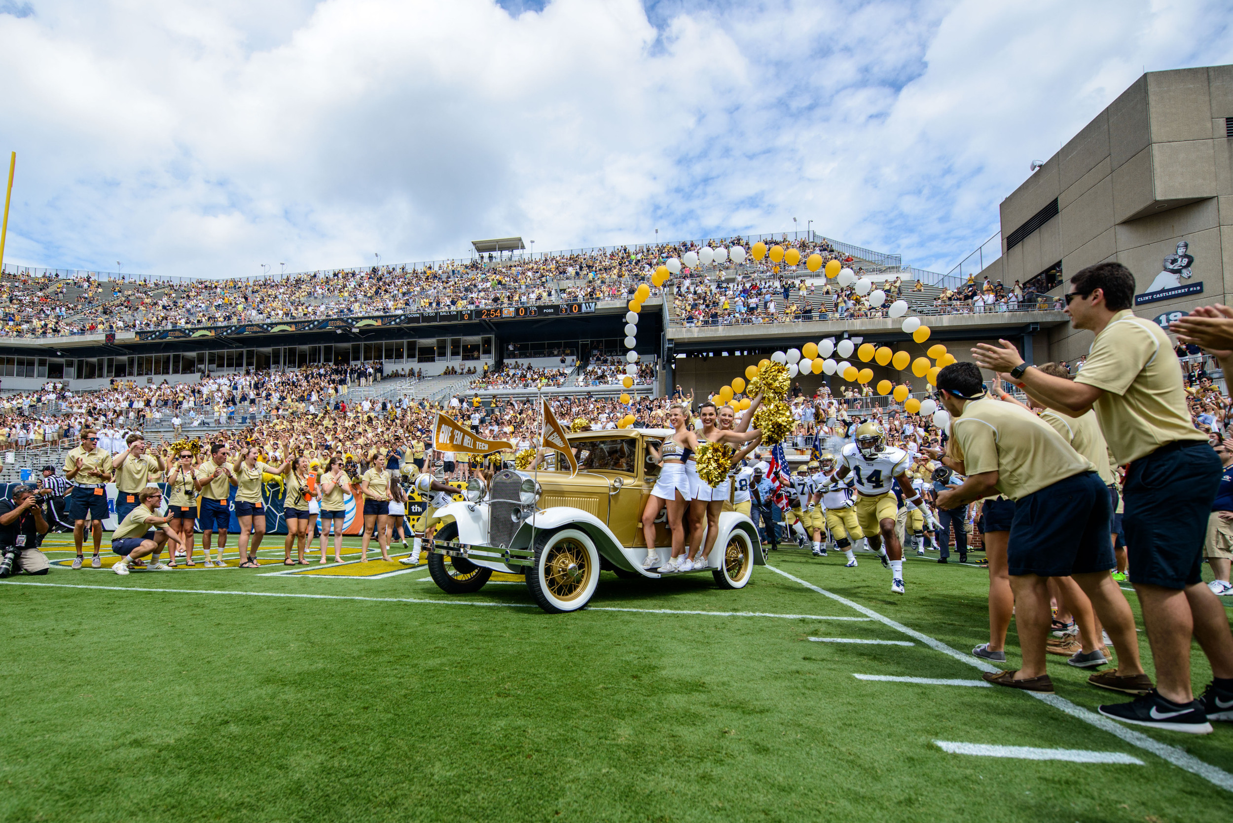 The Ramblin' Reck leads the team on the field
