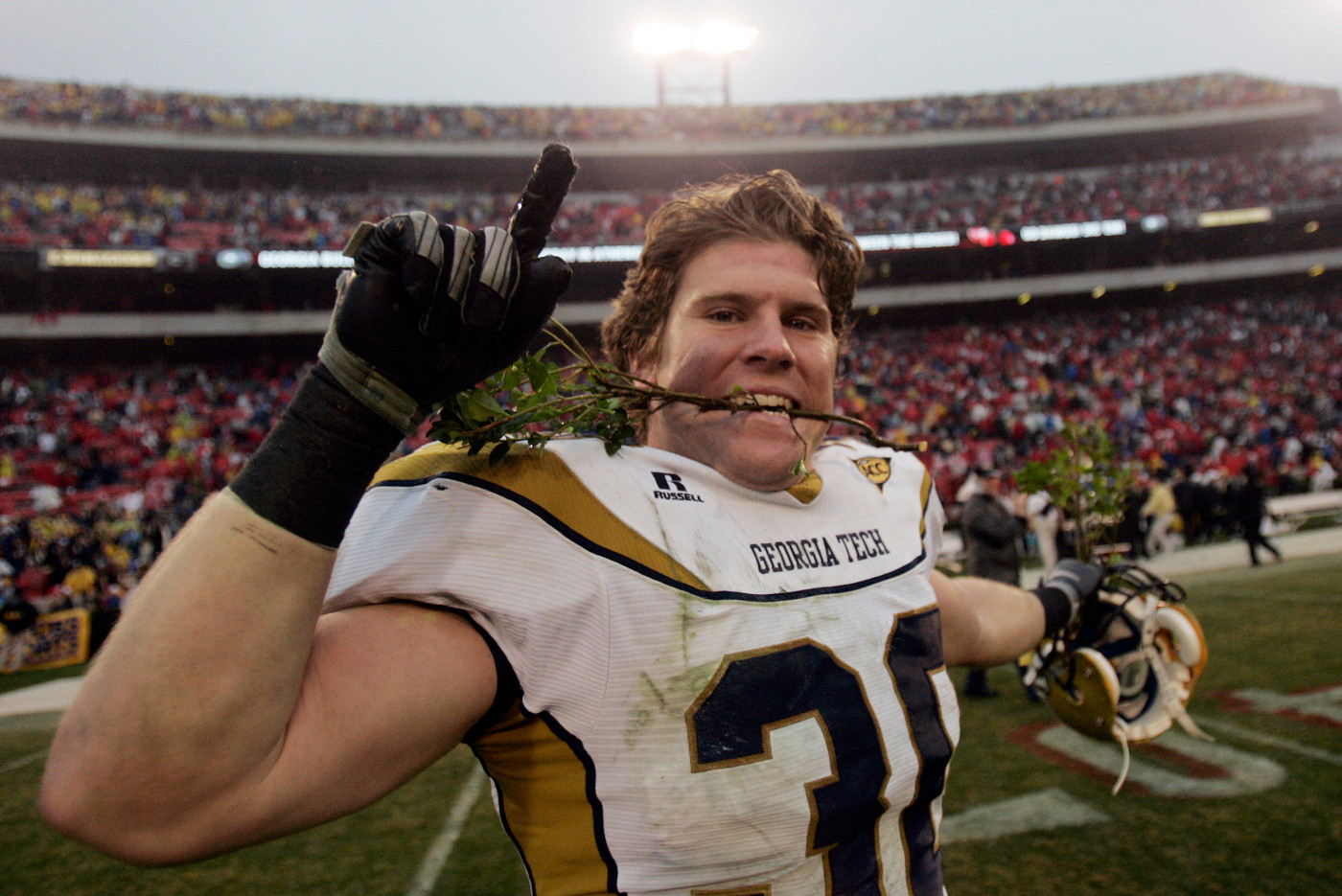James Liipfert holds a piece of the famed Sanford Stadium Hedge in his teeth as he celebrates Tech's 45-42 win over Georgia in Athens, Ga., , Saturday, Nov. 29, 2008 (AP Photo/John Bazemore)