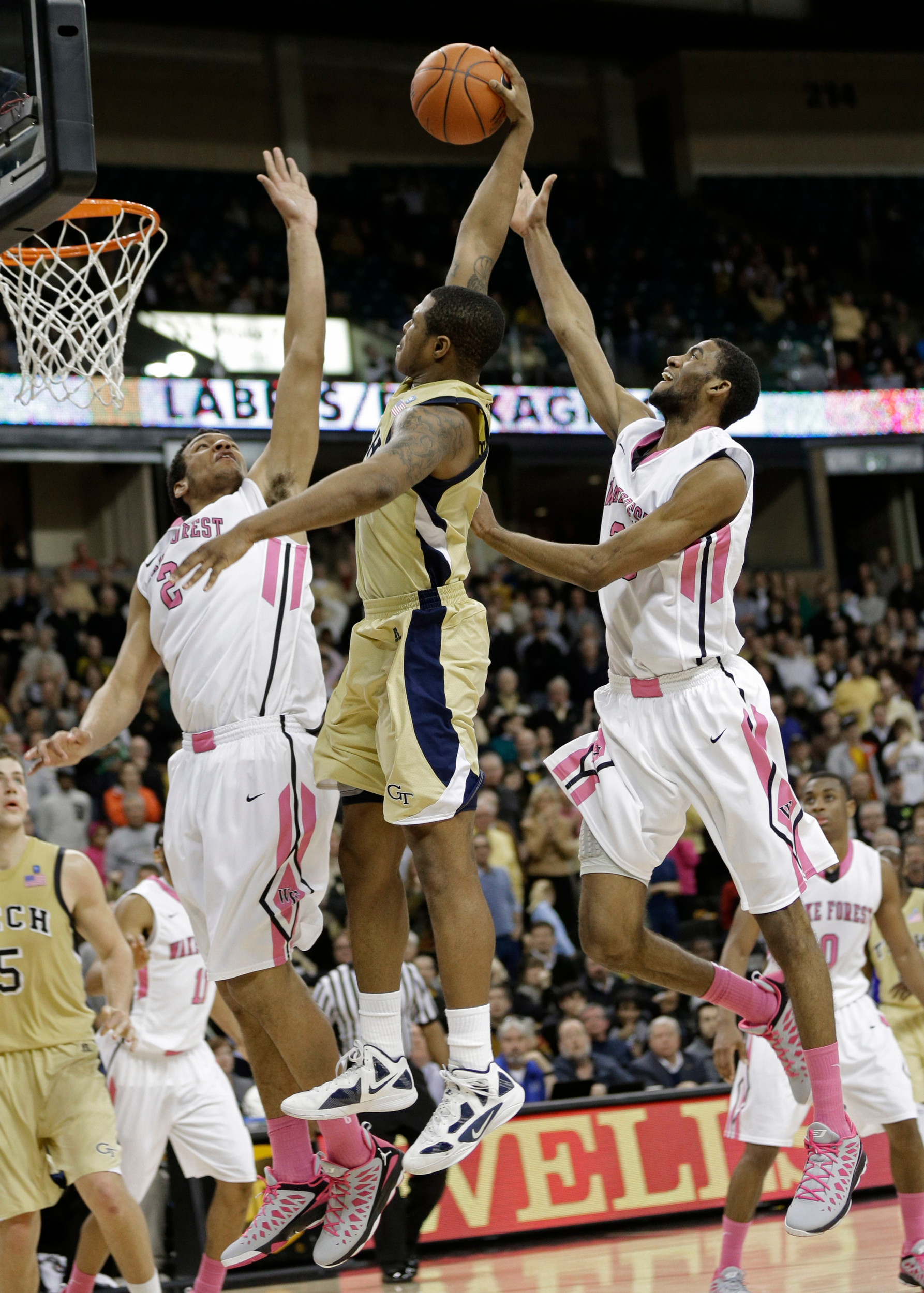 Georgia Tech's Marcus Georges-Hunt, center, tries to dunk against Wake Forest's Devin Thomas, left, and Aaron Rountree III, right, late during the second half. (AP Photo/Chuck Burton)