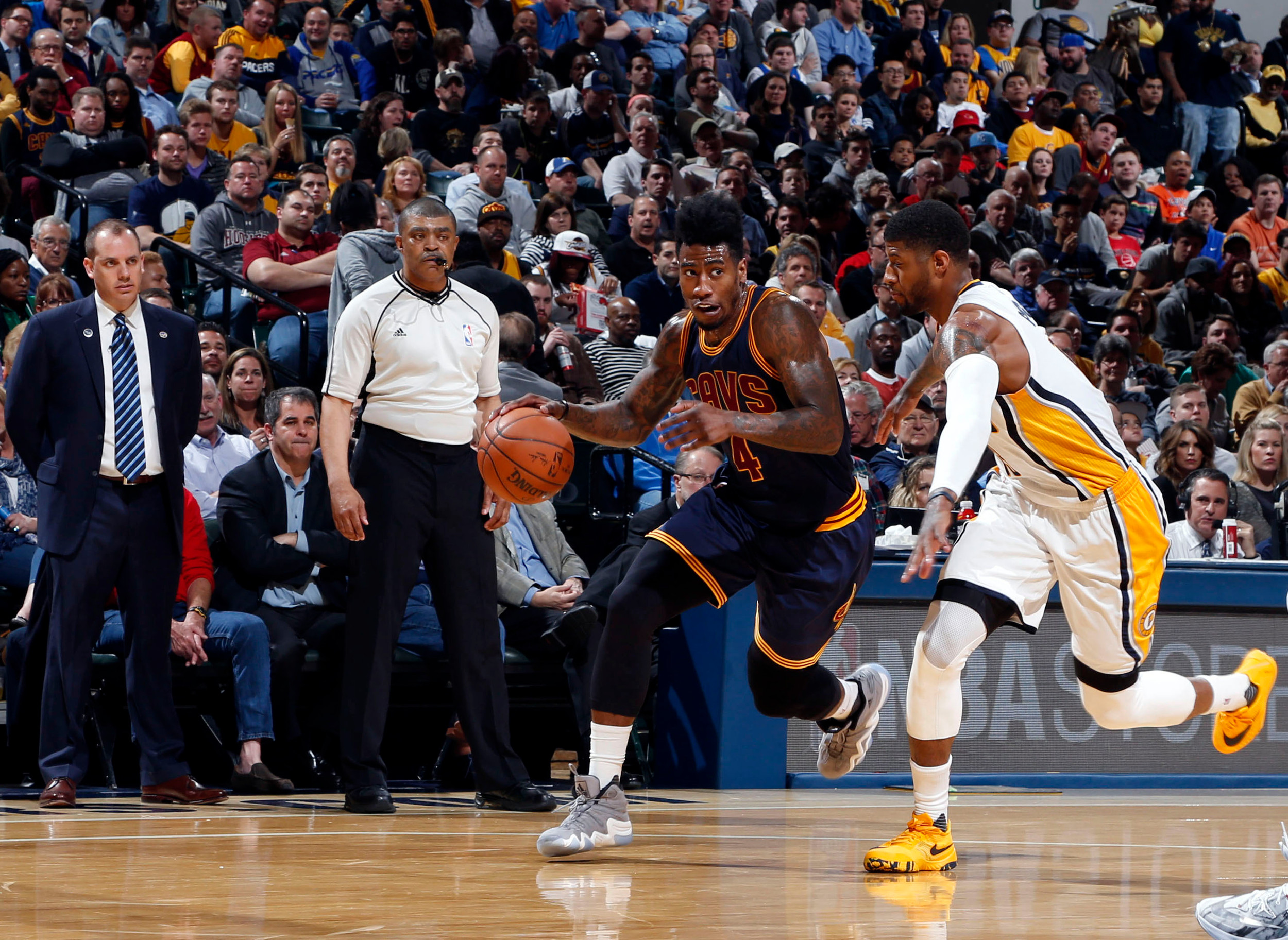Apr 6, 2016; Indianapolis, IN, USA; Cleveland Cavaliers forward Iman Shumpert (4) drives to the basket against Indiana Pacers forward Paul George (13). Credit: Brian Spurlock-USA TODAY Sports