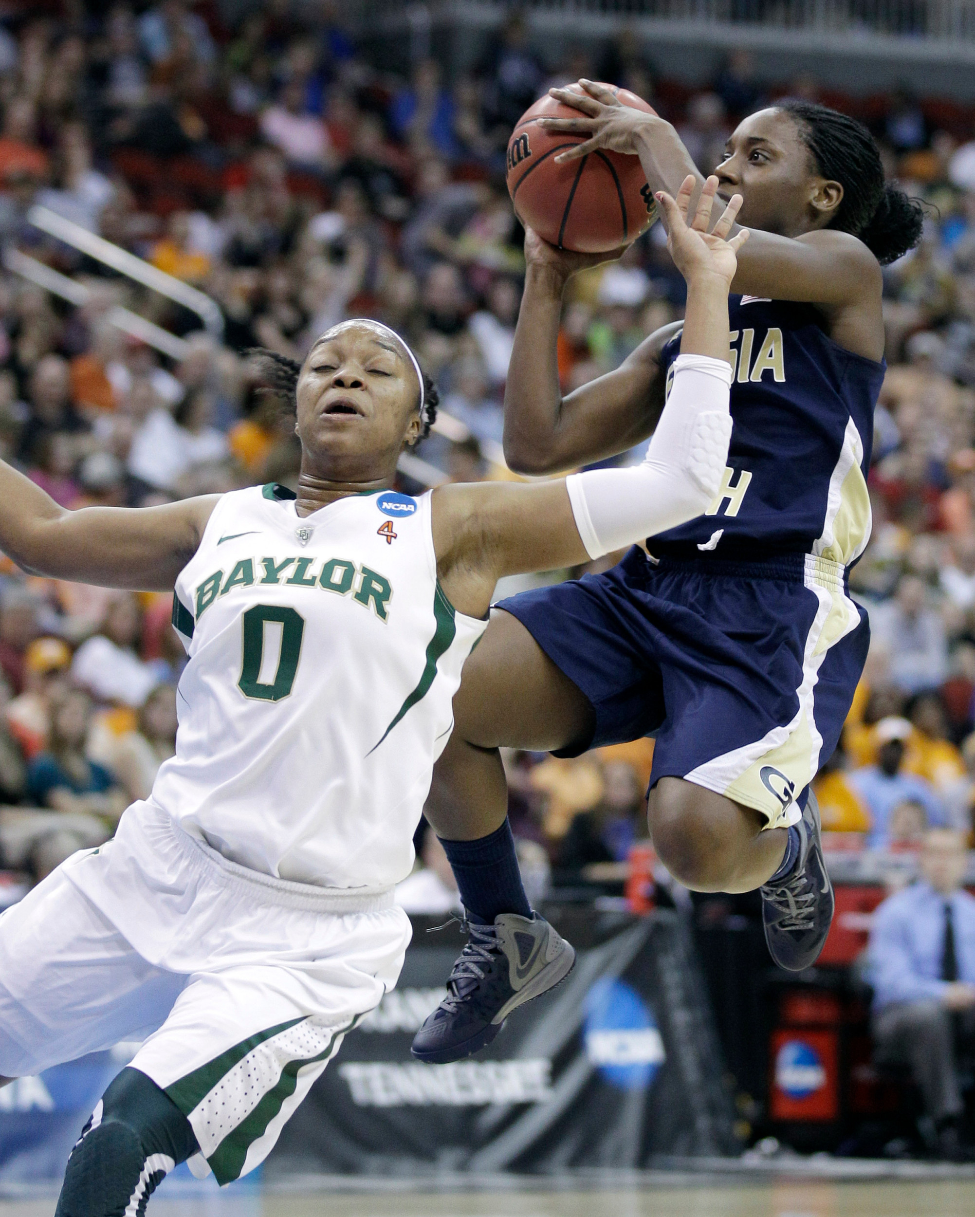 Georgia Tech guard Metra Walthour, right, shoots over Baylor guard Odyssey Sims (0) during the first half. (AP Photo/Charlie Neibergall)