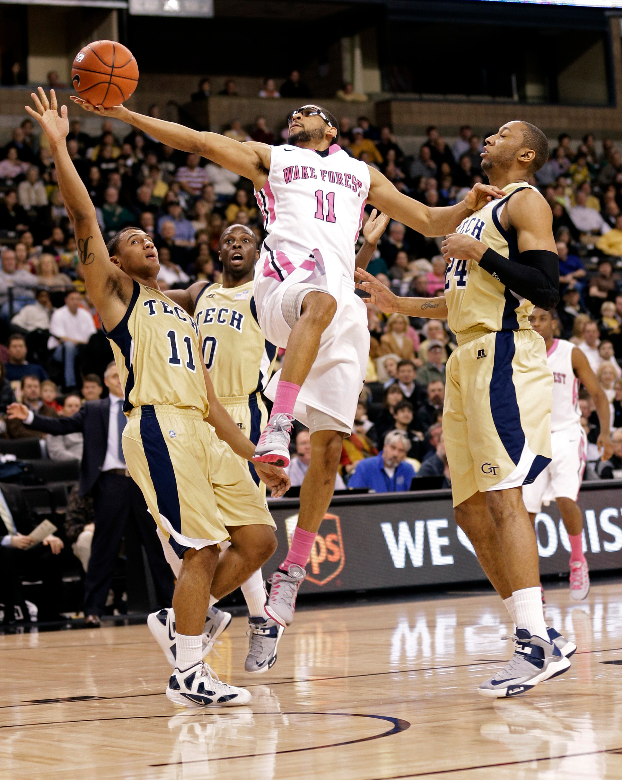 Wake Forest's C.J. Harris, center, drives between Georgia Tech's Chris Bolden, left, Mfon Udofia, second from left, and Kammeon Holsey, right, during the first half. (AP Photo/Chuck Burton)