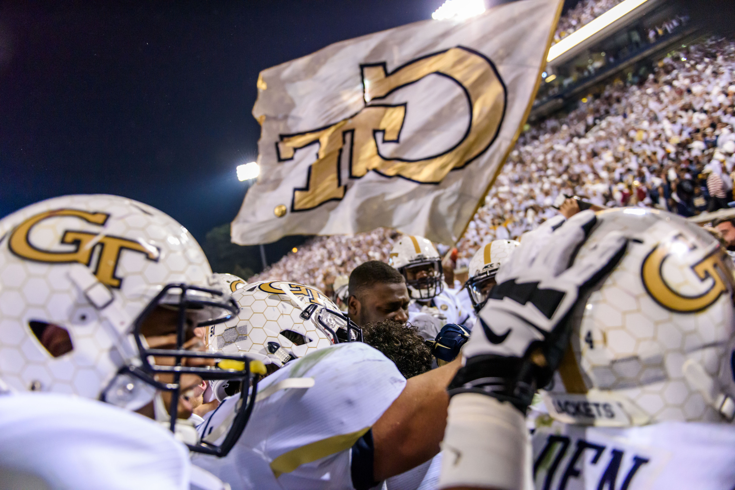 The team swarms Lance Austin (17) after his game-winning score
