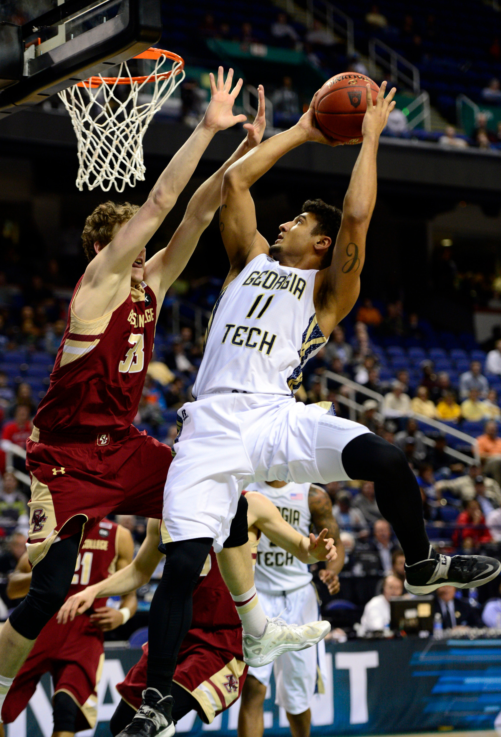 Mar 12, 2014; Greensboro, NC, USA; Georgia Tech Yellow Jackets guard Chris Bolden (11) drives to the basket against Boston College Eagles guard Patrick Heckmann (33) during the first round of the ACC Tournament at Greensboro Coliseum. Mandatory Credit: John David Mercer-USA TODAY Sports