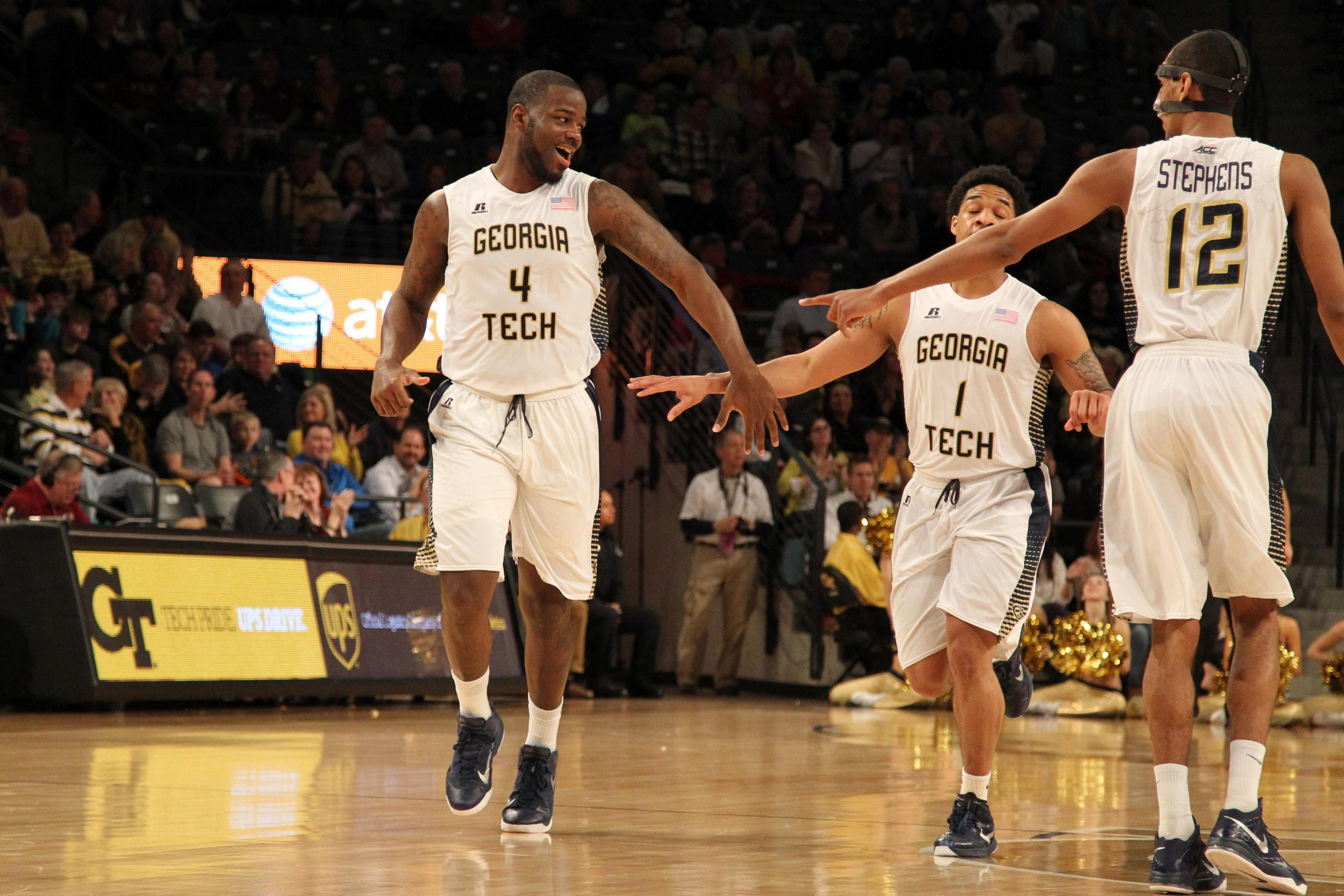 Feb 14, 2015; Atlanta, GA, USA; Georgia Tech Yellow Jackets center Demarco Cox (4) celebrates a basket with guard Tadric Jackson (1) and forward Quinton Stephens (12) against the Florida State Seminoles in the first half at McCamish Pavilion.