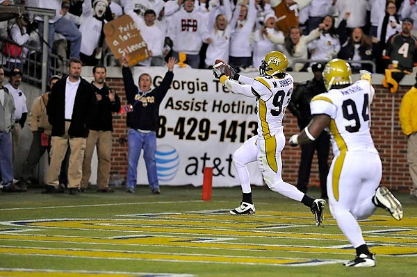 Michael Johnson (93) returns an interception for a touchdown. (Photo by Lenseffects)