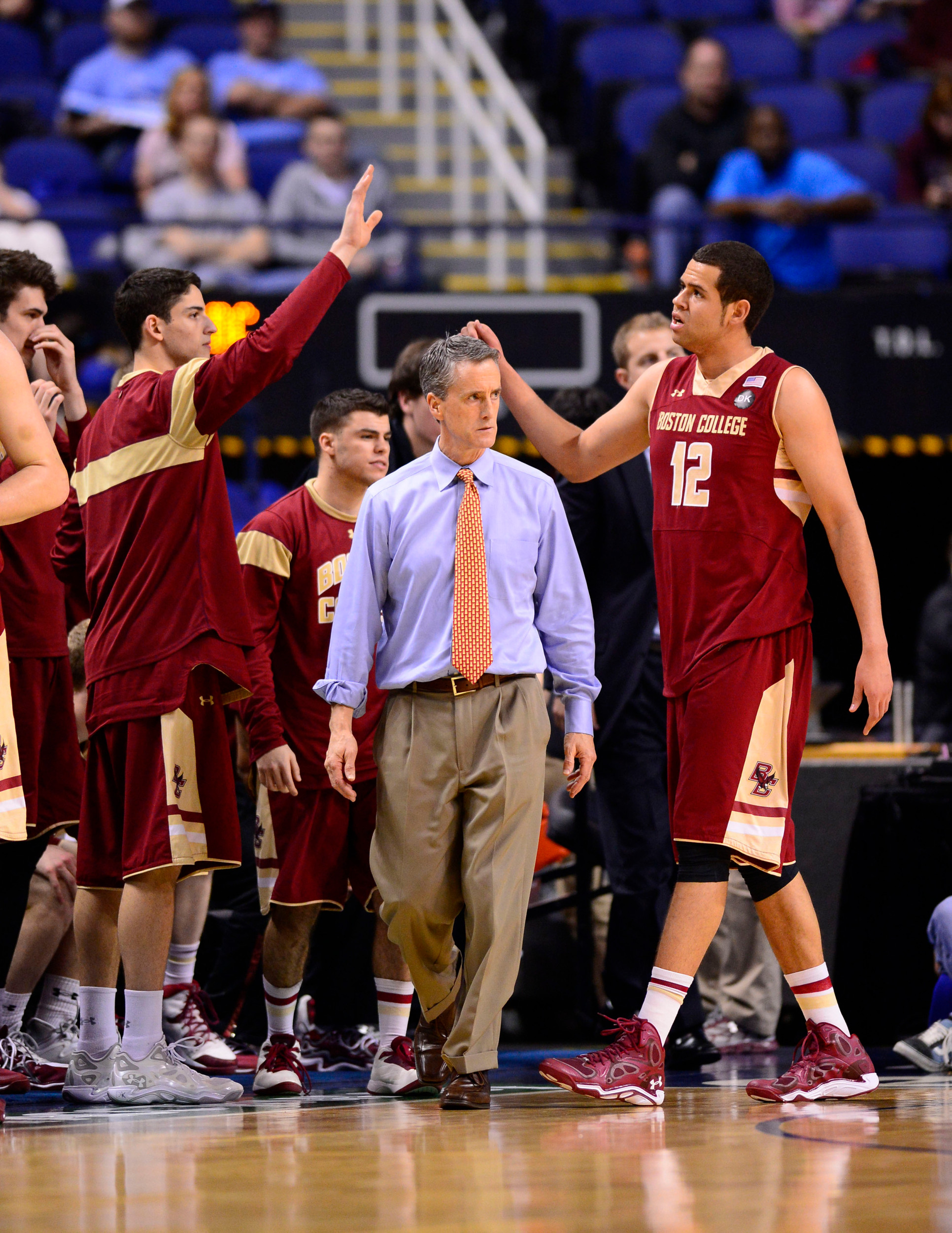 Mar 12, 2014; Greensboro, NC, USA; Boston College Eagles head coach Steve Donahue on the sidelines as forward Ryan Anderson (12) is in the background in the first half in the first round at Greensboro Coliseum. Mandatory Credit: Bob Donnan-USA TODAY Sports