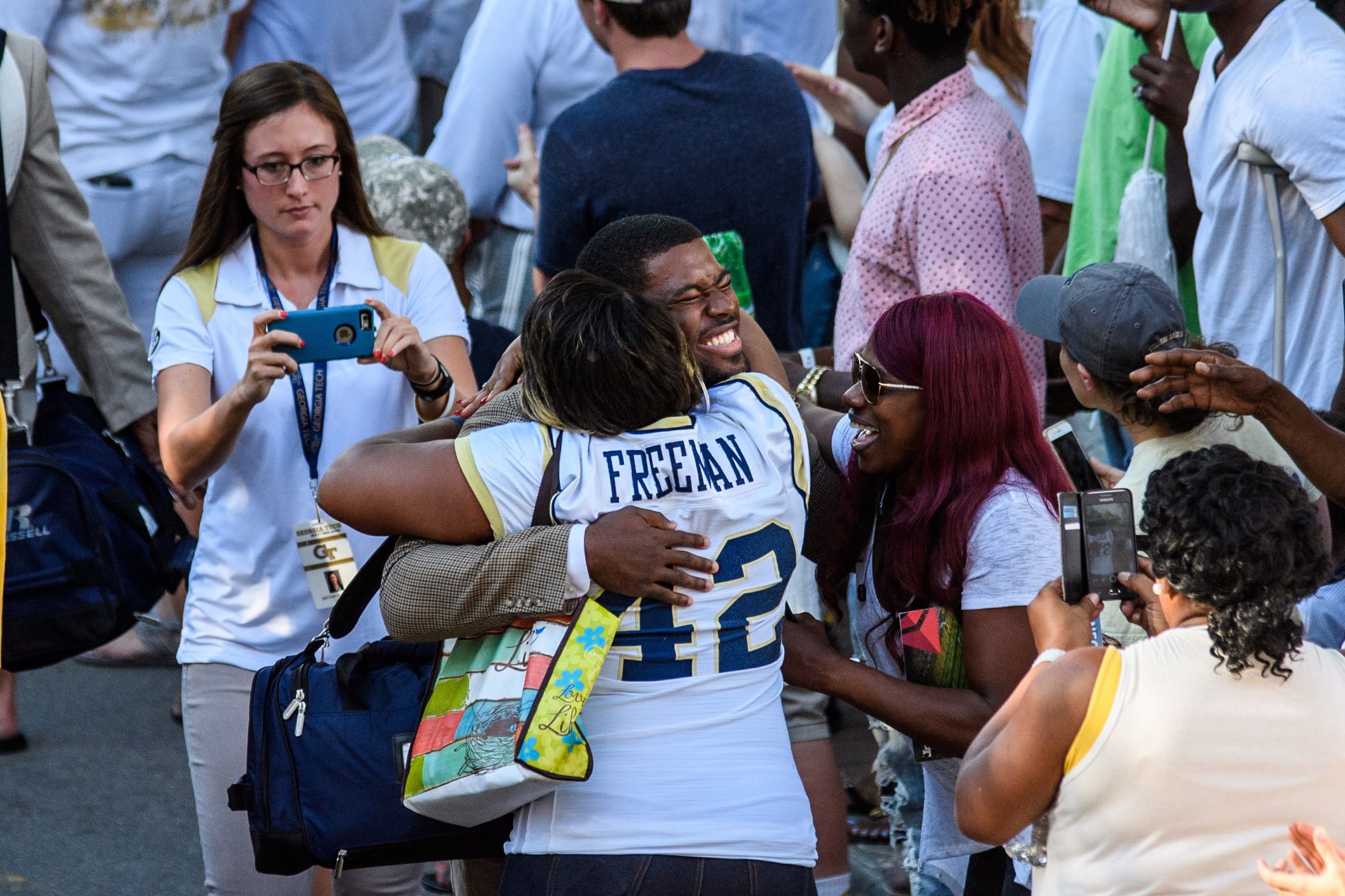KeShun Freeman (42) stops for hugs on the way down Yellow Jacket Alley
