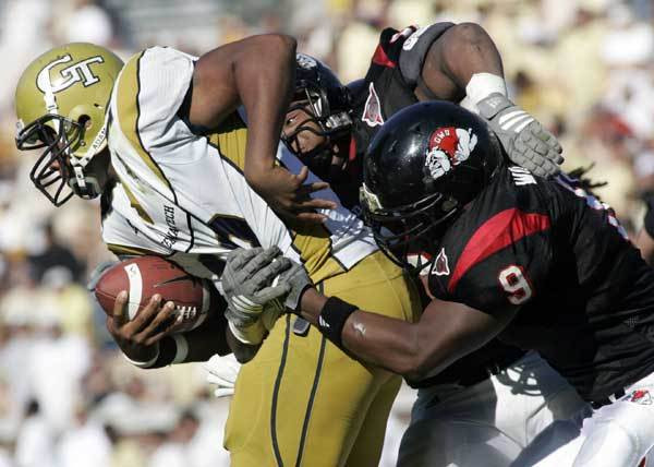 Georgia Tech quarterback Calvin Booker, left, is sacked by Gardner Webb linebacker Jeffrey Williams (9) and Quinnon Isom during the first half.