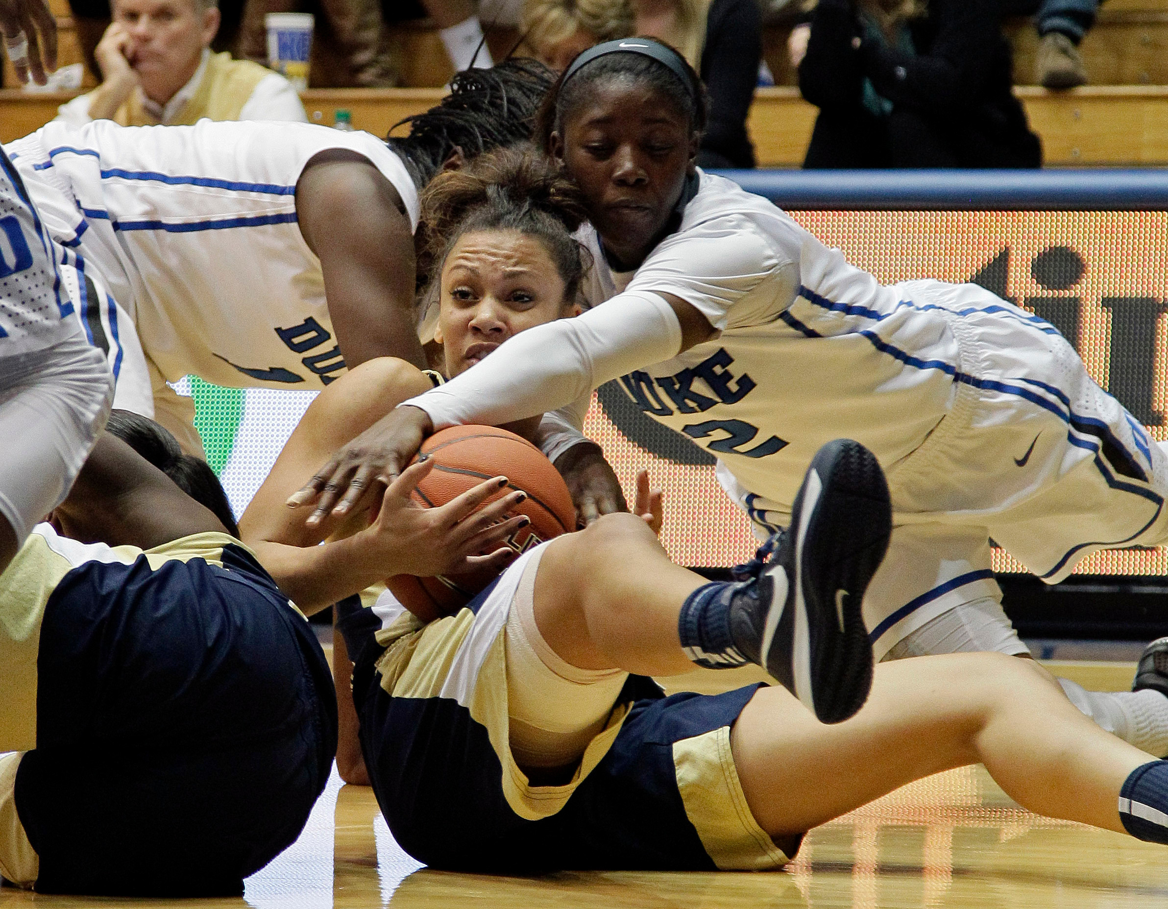 Duke's Alexis Jones (2) and Elizabeth Williams, rear, struggle for possession with Georgia Tech's Danielle Hamilton-Carter during the first half of an NCAA women's college basketball game in Durham, N.C., Thursday, Dec. 6, 2012. (AP Photo/Gerry Broome)