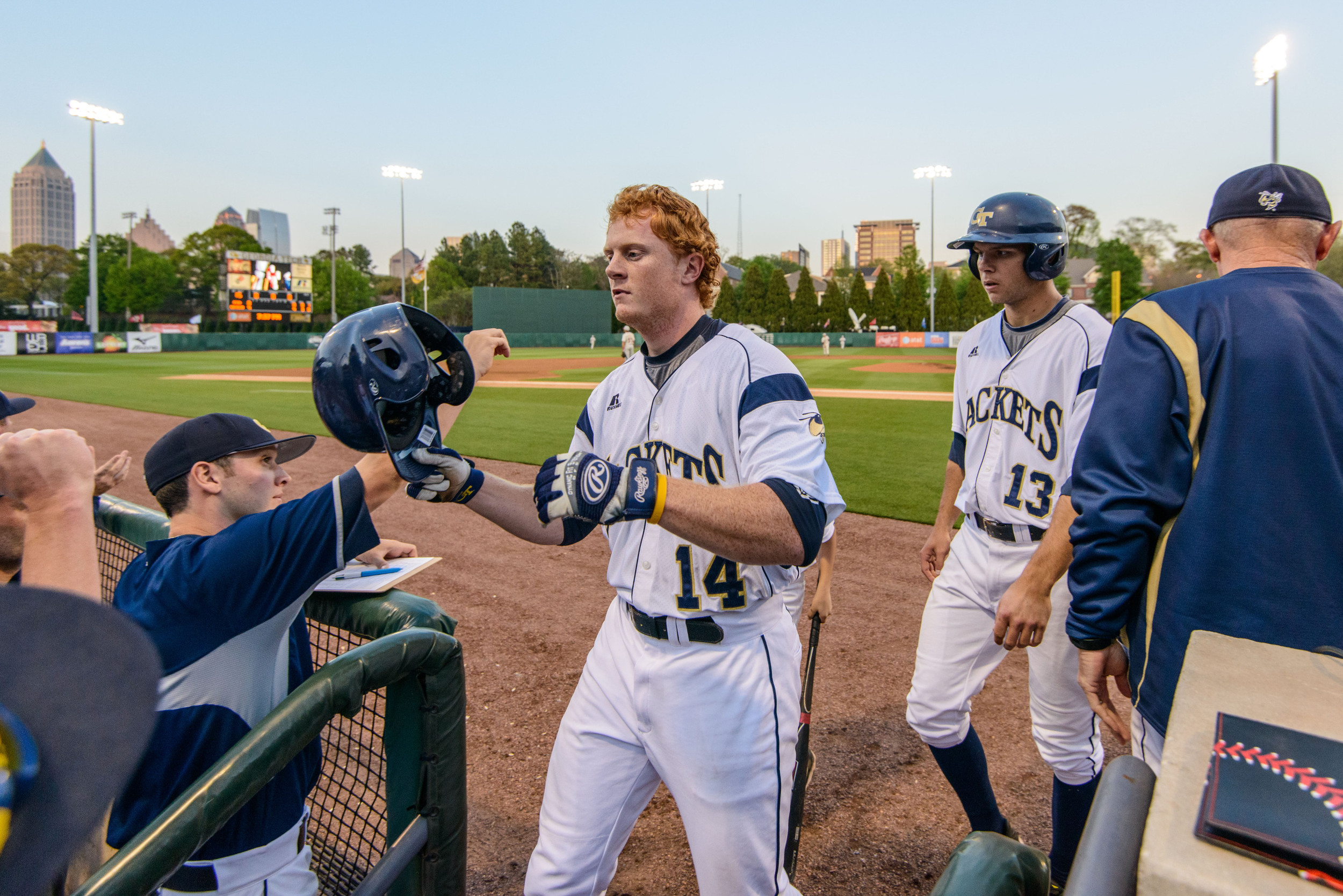 Matt Gonzalez (14) and Thomas Smith (13) are welcomed back to the dugout after scoring runs