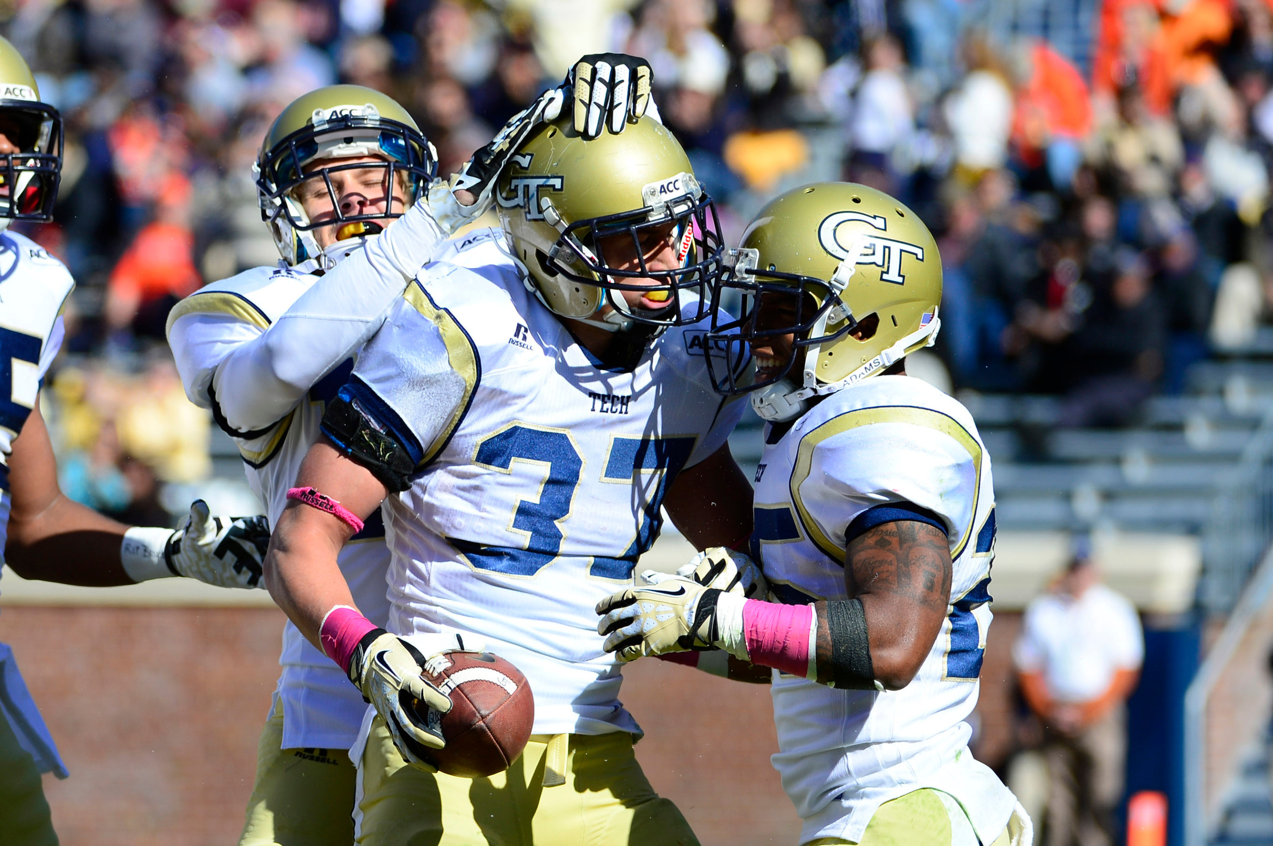 Zach Laskey (37) celebrates with wide receiver Corey Dennis (16) and running back Robert Godhigh (25) after scoring a touchdown. Mandatory Credit: Bob Donnan-USA TODAY Sports